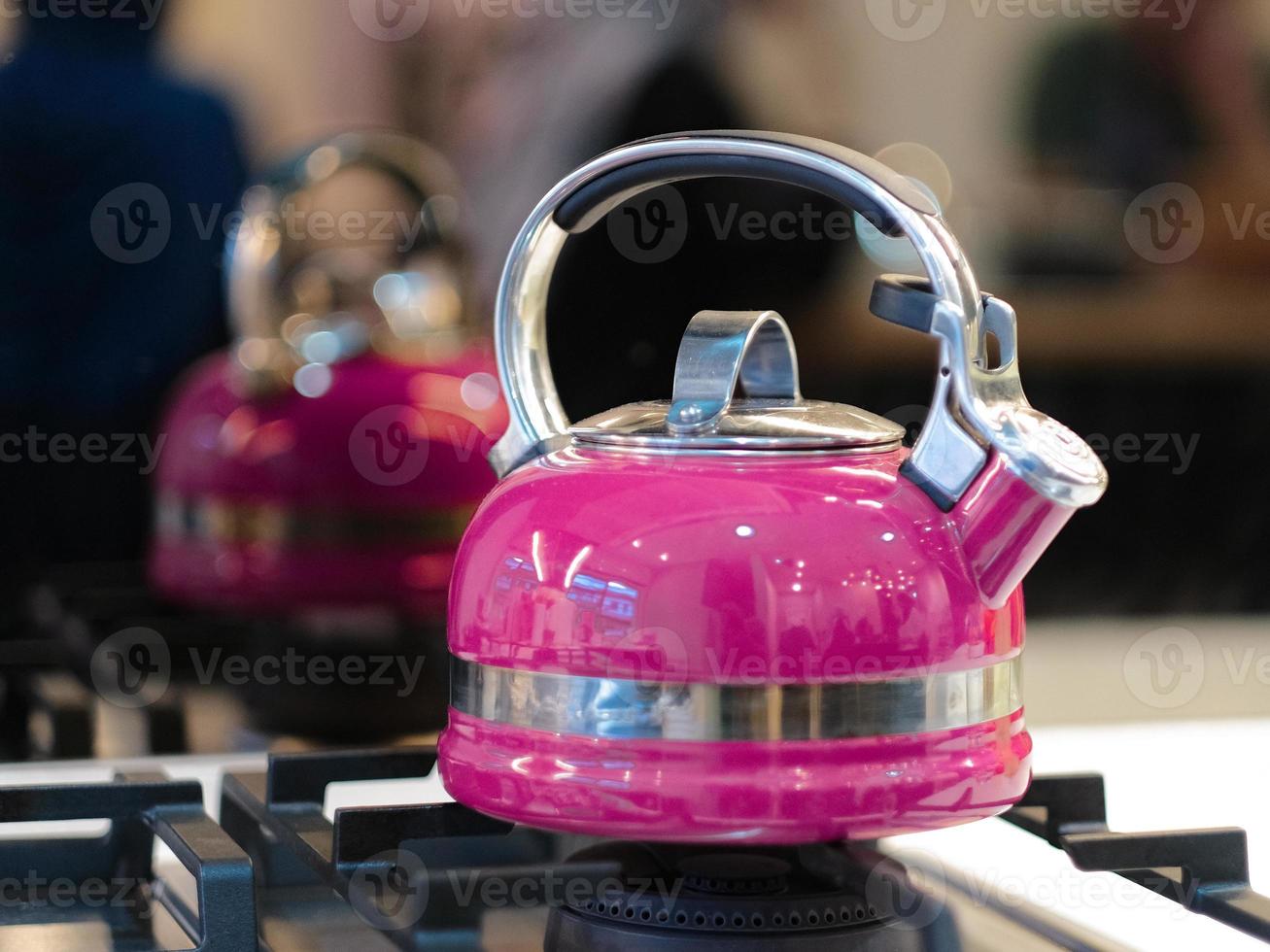 Pink kettle  on a stove, photo