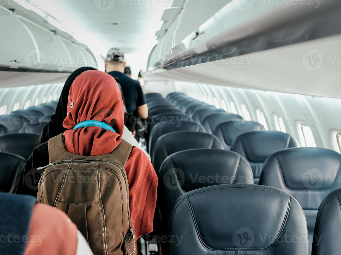 Passengers queuing to disembark the aircraft photo