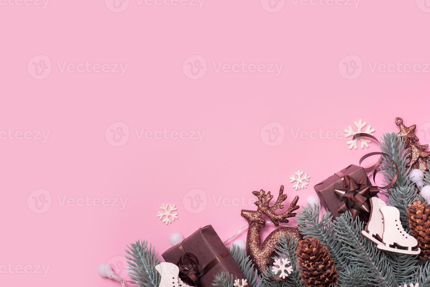 Pine trees branches with Cristmas New Year decoration top view, flat lay on pink background with copy space. Blank greeting card photo