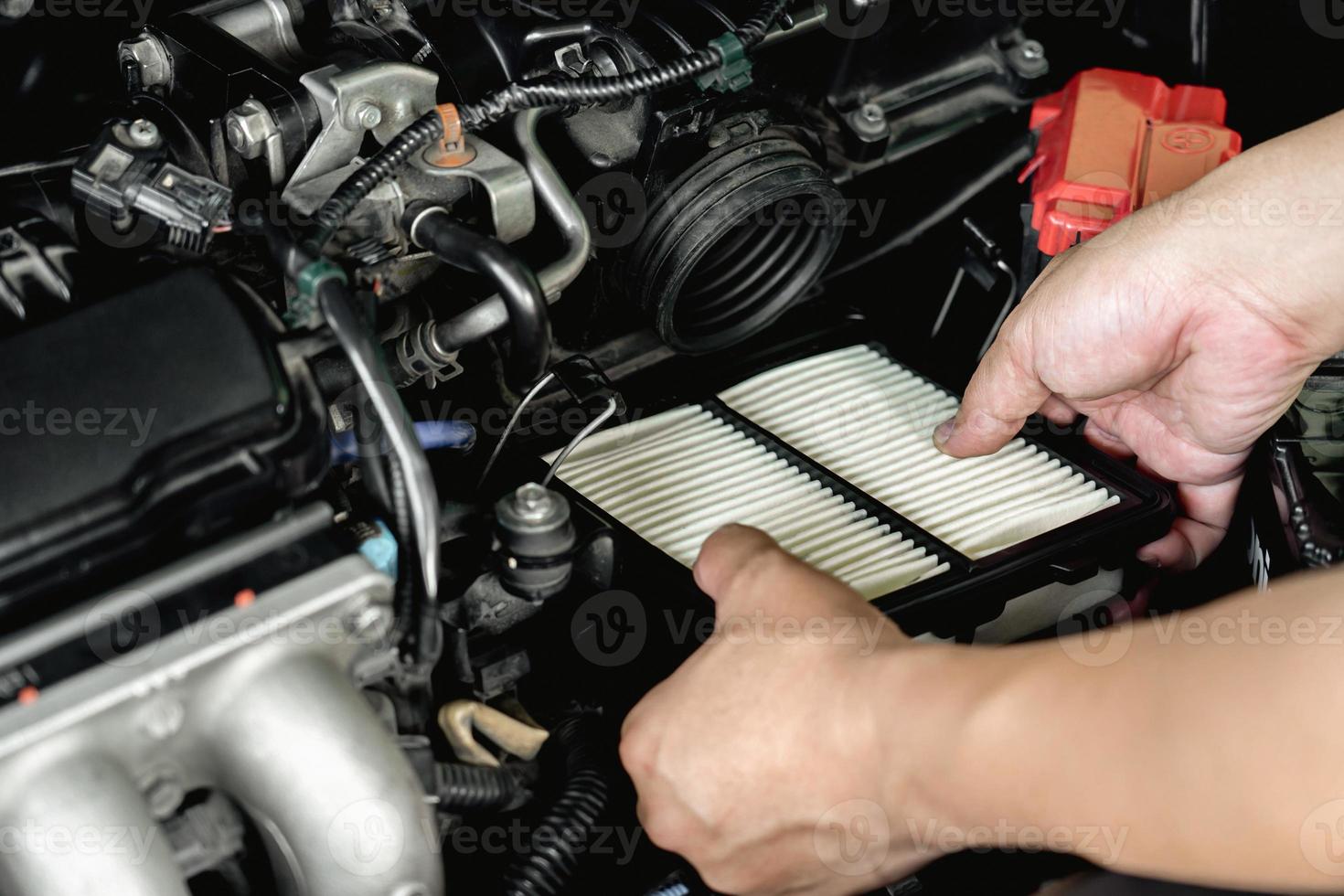 Hand a man input new air filter of car engine in engine room basic concept in maintenance of a car photo