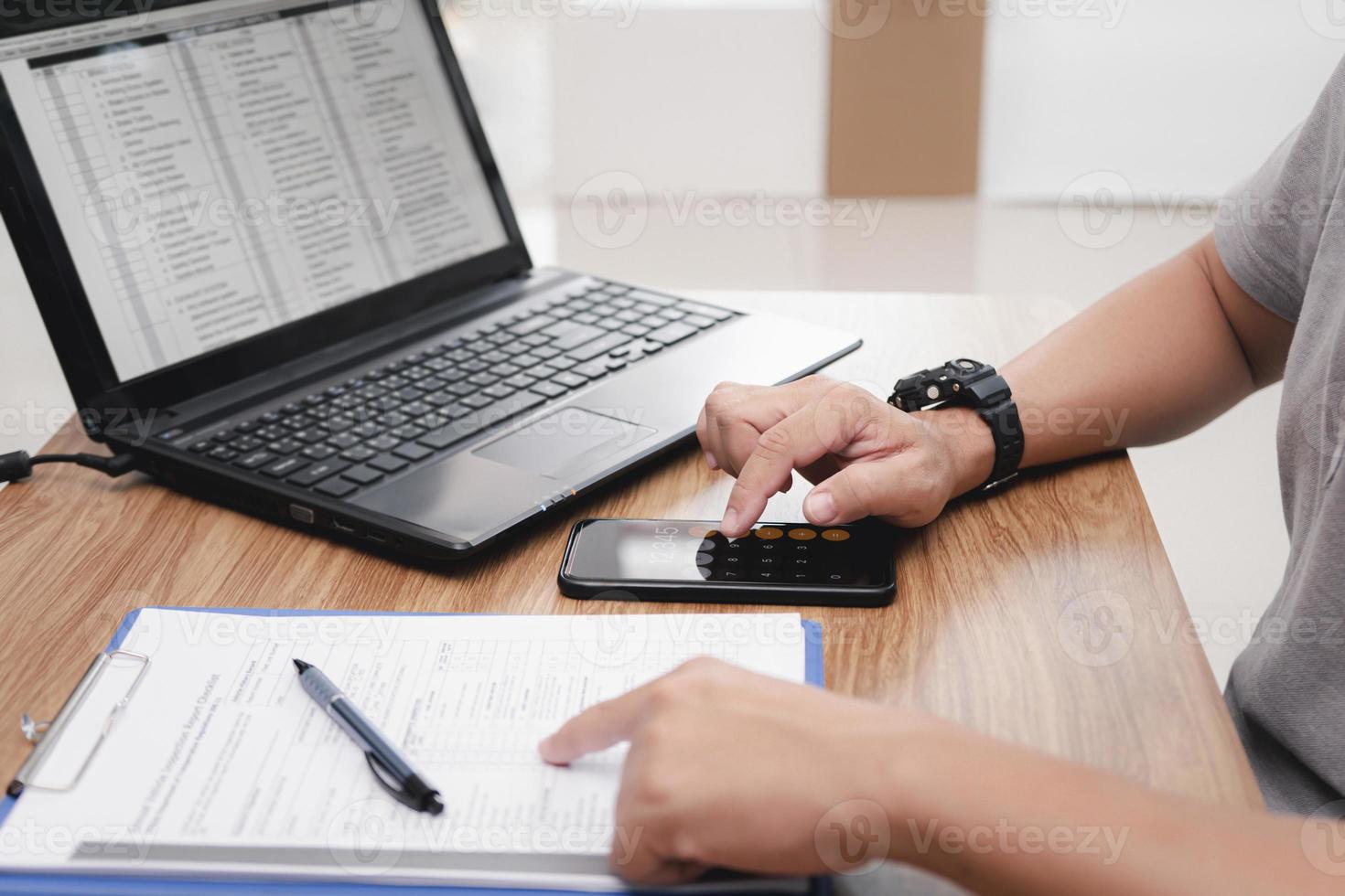 Service staff use smartphone calculate cost of repairing the car from the damage assessment document and use laptop on table office service center photo