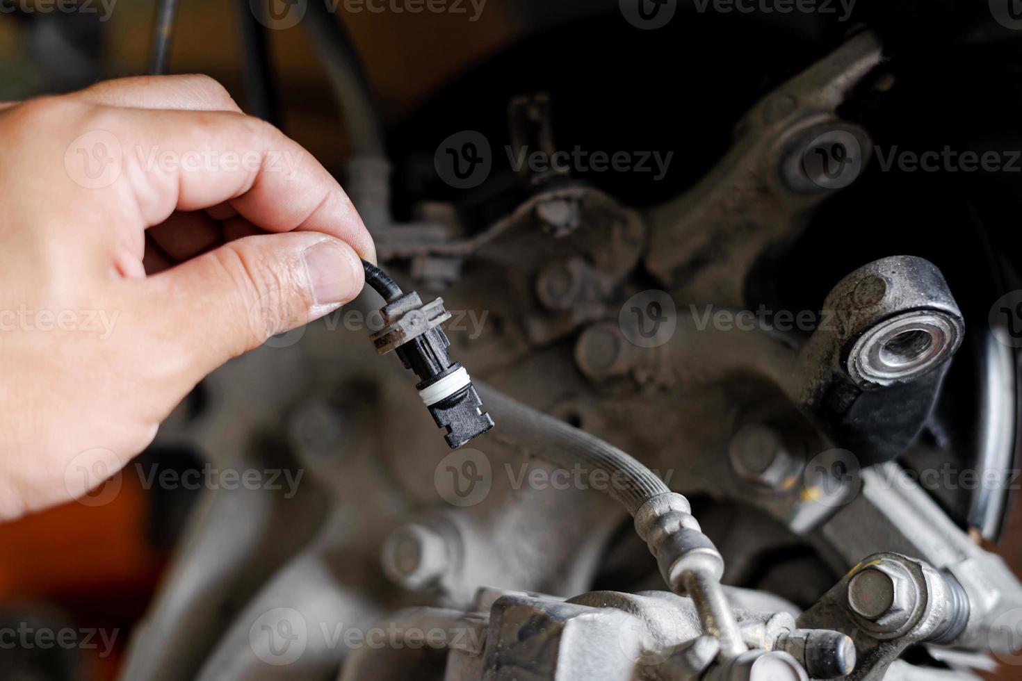 Close up ABS brake sensor of car wheel check for abnormalities to ensure the safety of the brakes service concept photo