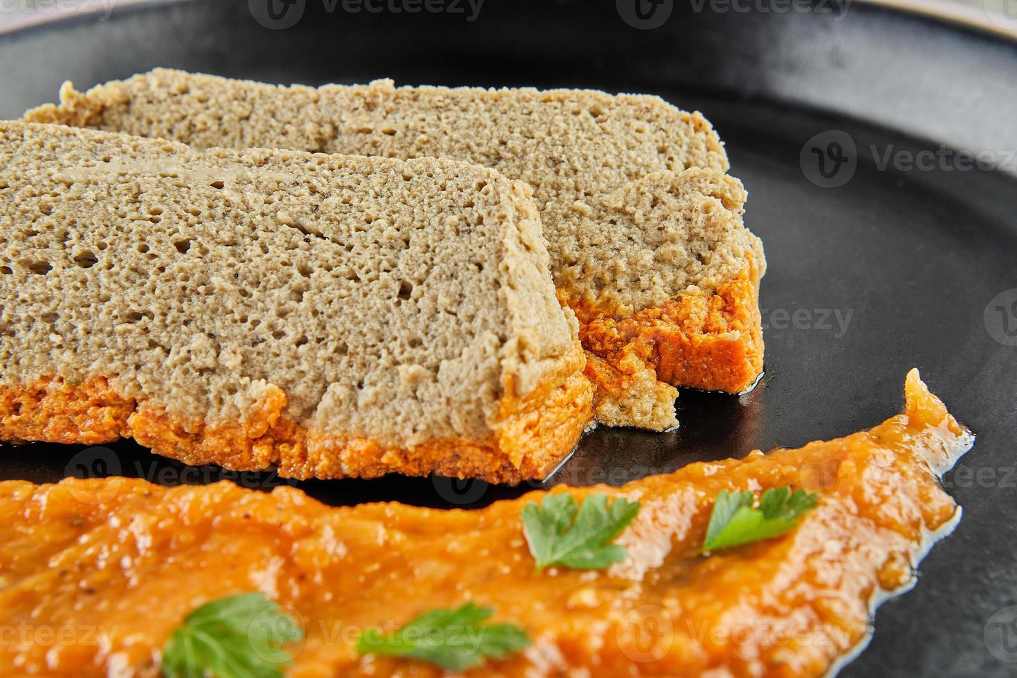 Eggplant terrine with tomato sauce and parsley photo