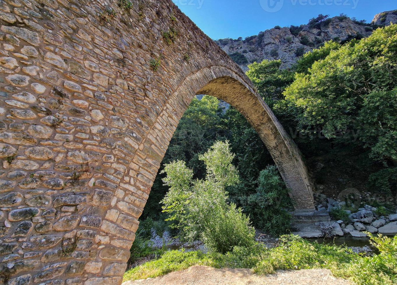 Portaikos River single arch Bridge at Pyli, Greece photo