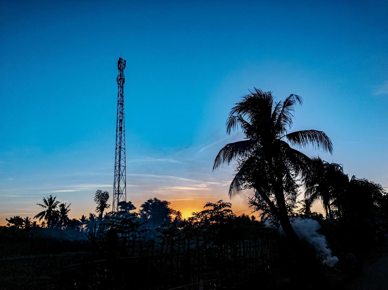 sunrise in the morning in a village in the middle of rice fields photo