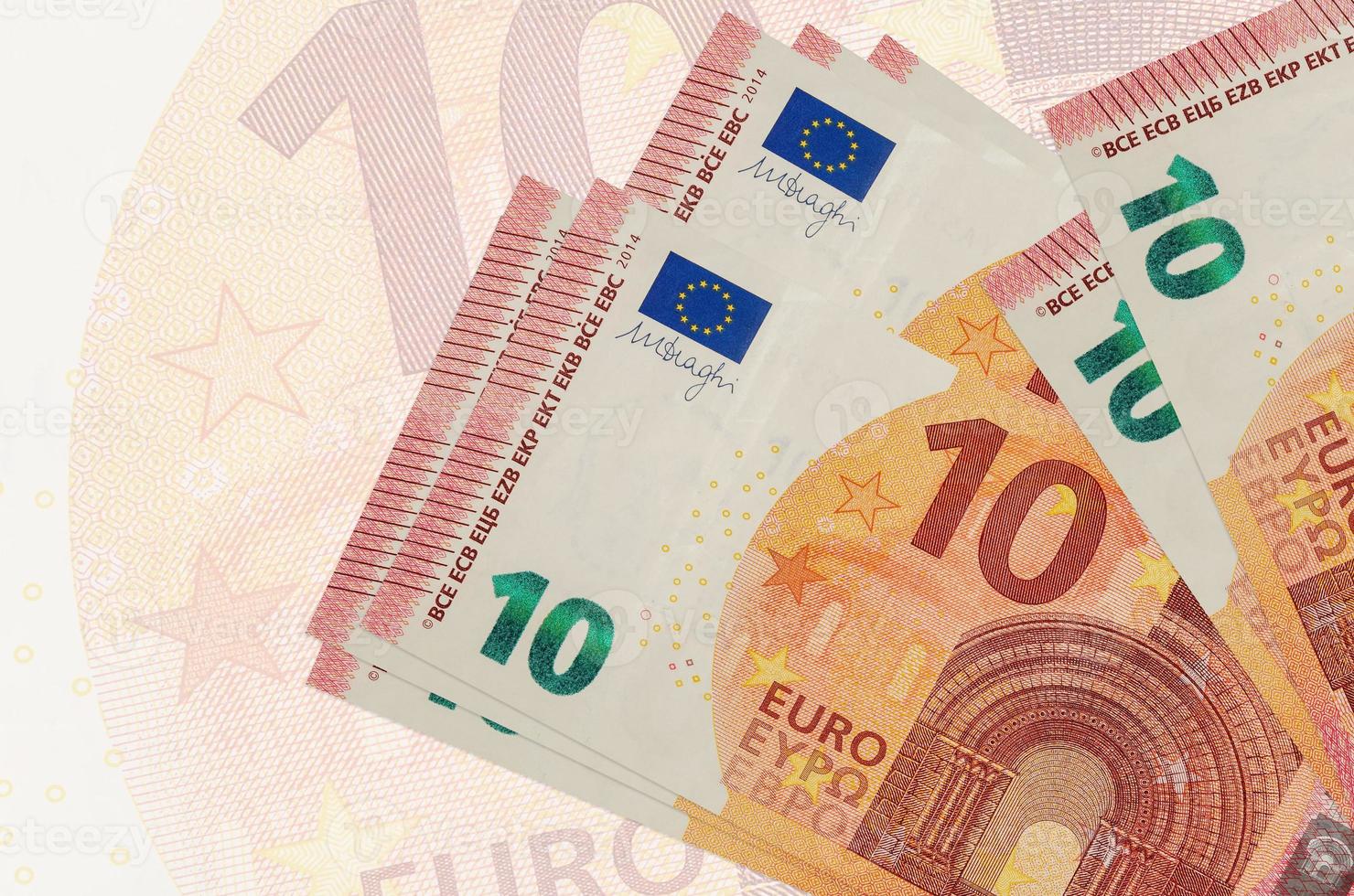 10 euro bills lies in stack on background of big semi-transparent banknote. Abstract presentation of national currency photo