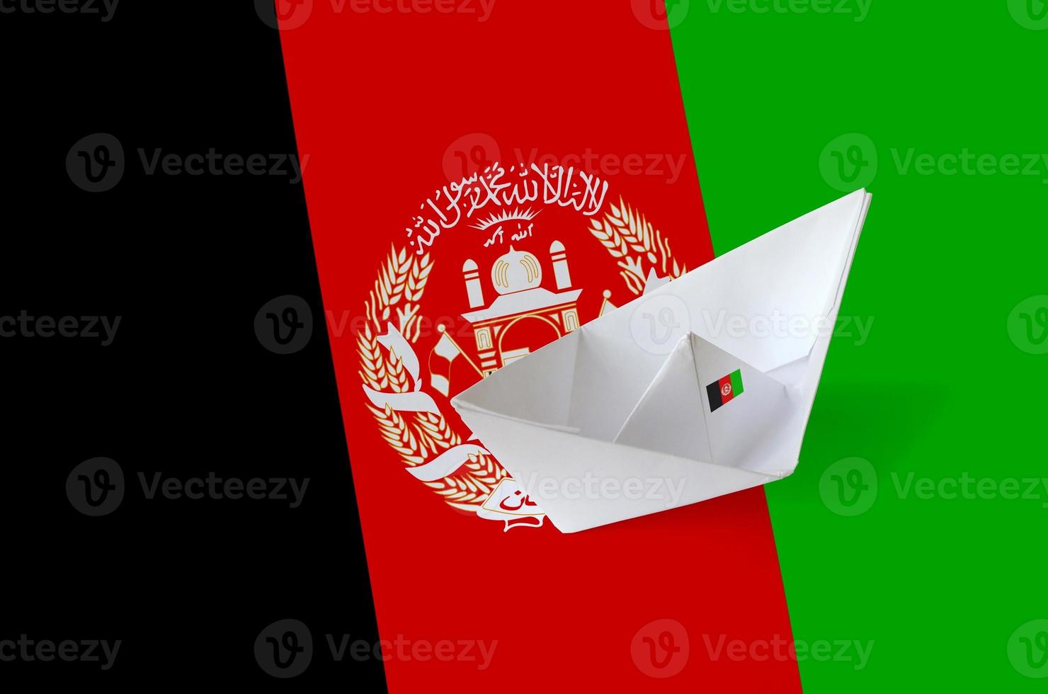 Afghanistan flag depicted on paper origami ship closeup. Handmade arts concept photo
