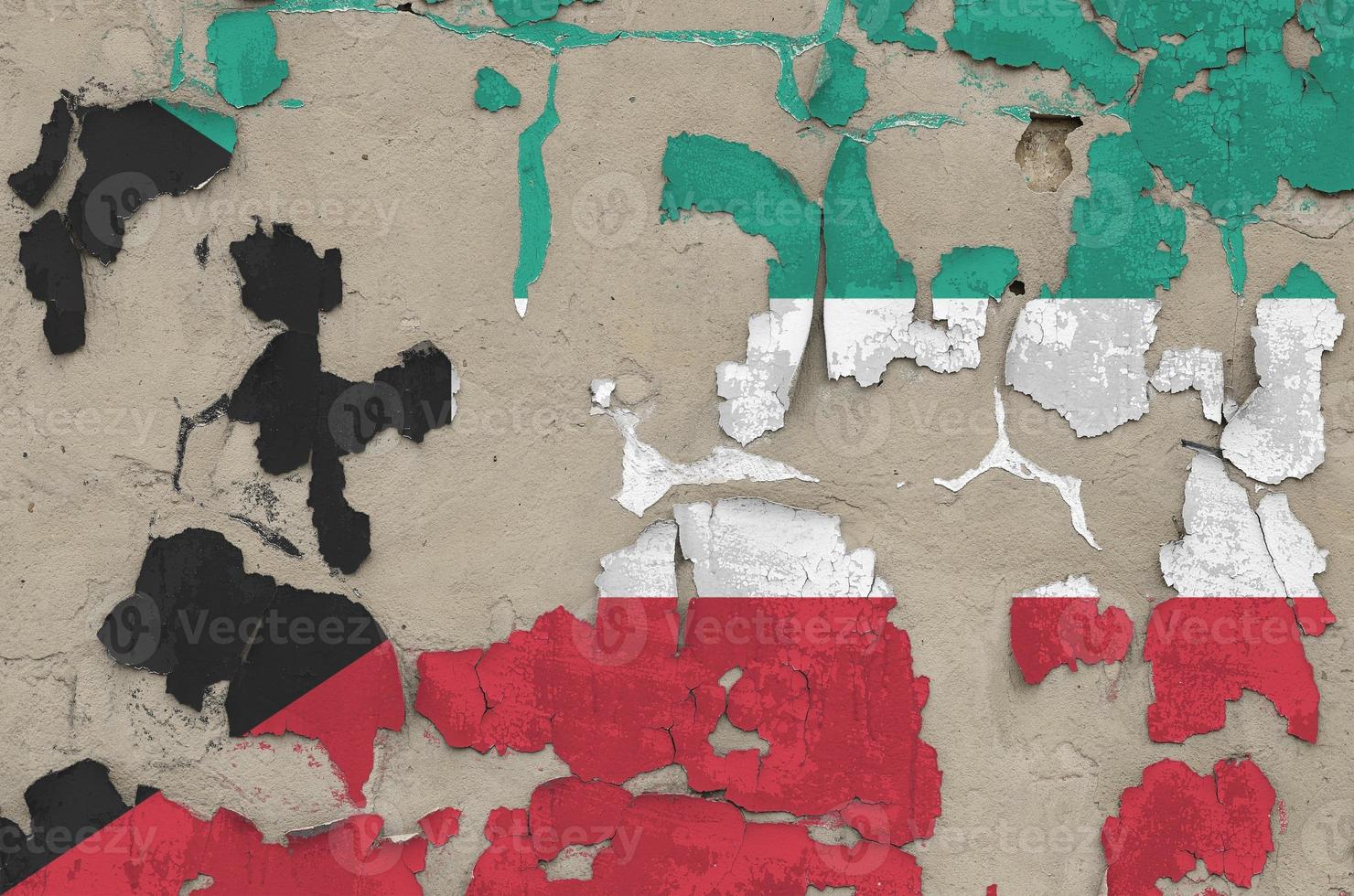 Kuwait flag depicted in paint colors on old obsolete messy concrete wall closeup. Textured banner on rough background photo