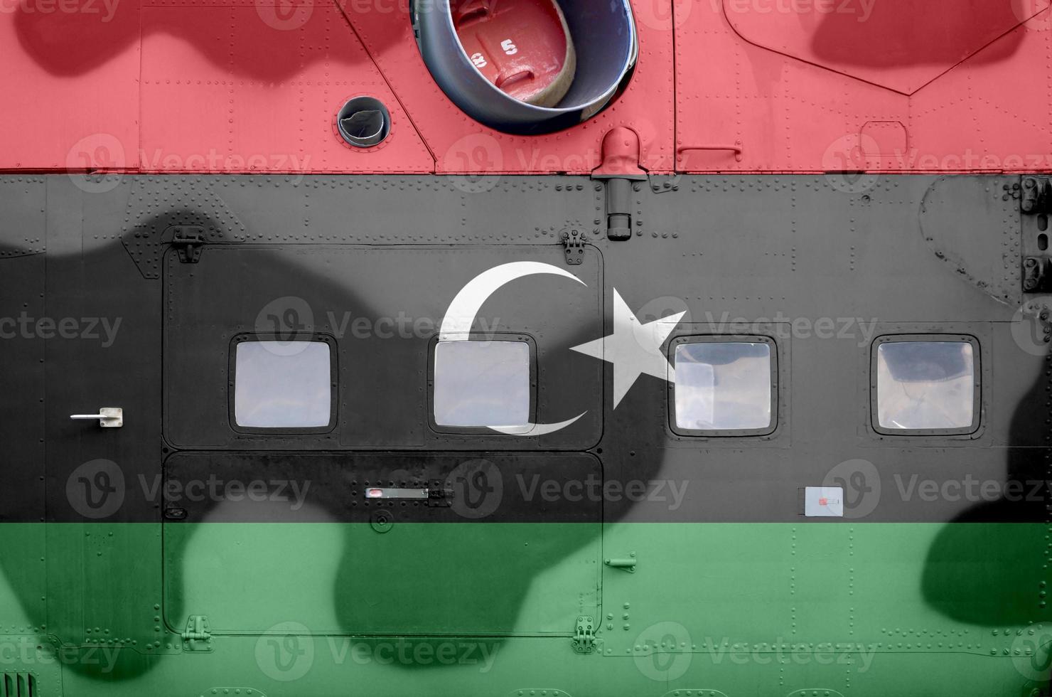 Libya flag depicted on side part of military armored helicopter closeup. Army forces aircraft conceptual background photo