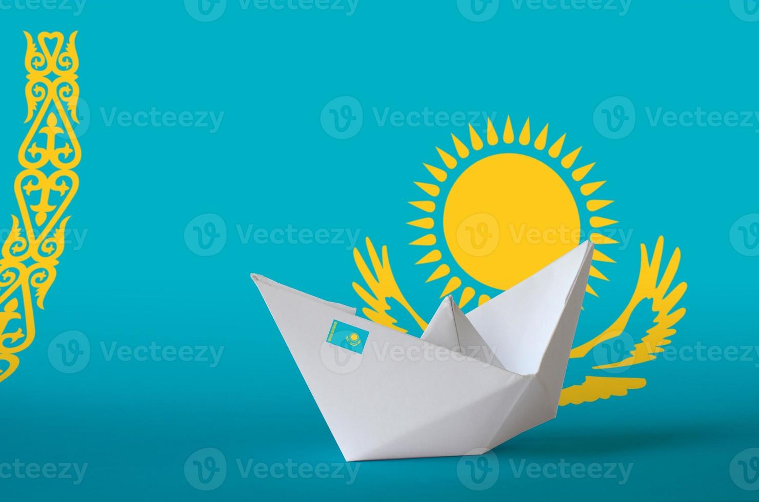 Kazakhstan flag depicted on paper origami ship closeup. Handmade arts concept photo