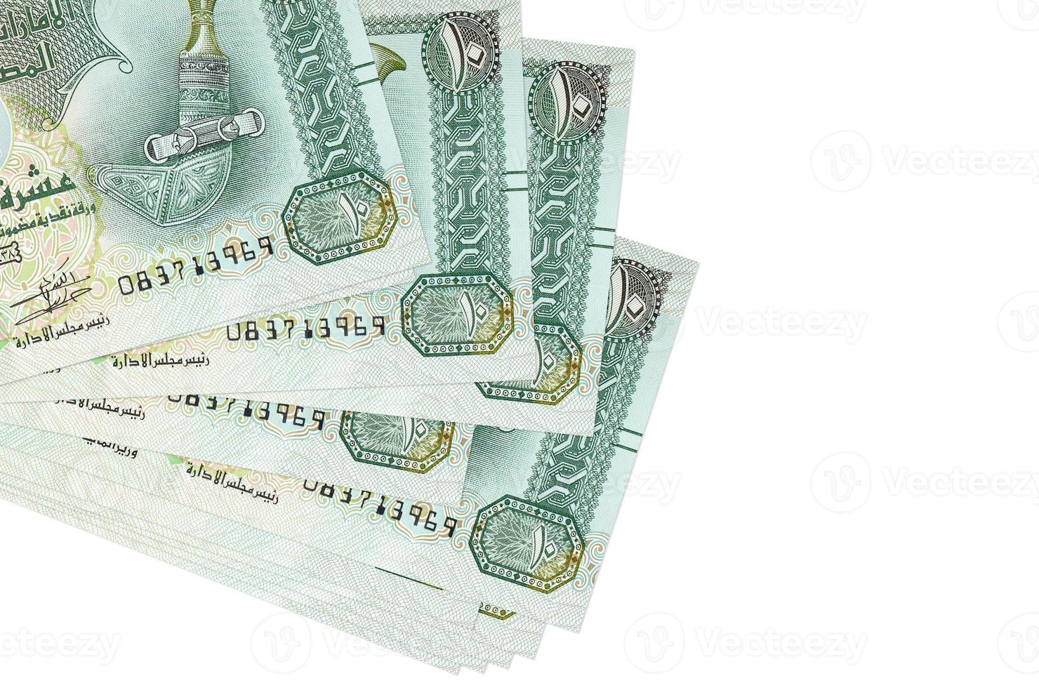 10 UAE dirhams bills lies in small bunch or pack isolated on white. Mockup with copy space. Business and currency exchange photo