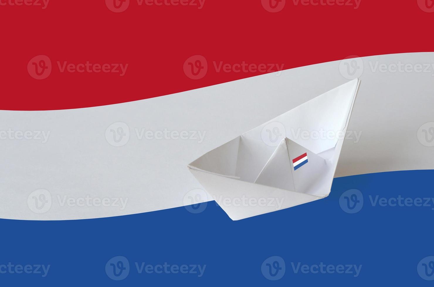Netherlands flag depicted on paper origami ship closeup. Handmade arts concept photo
