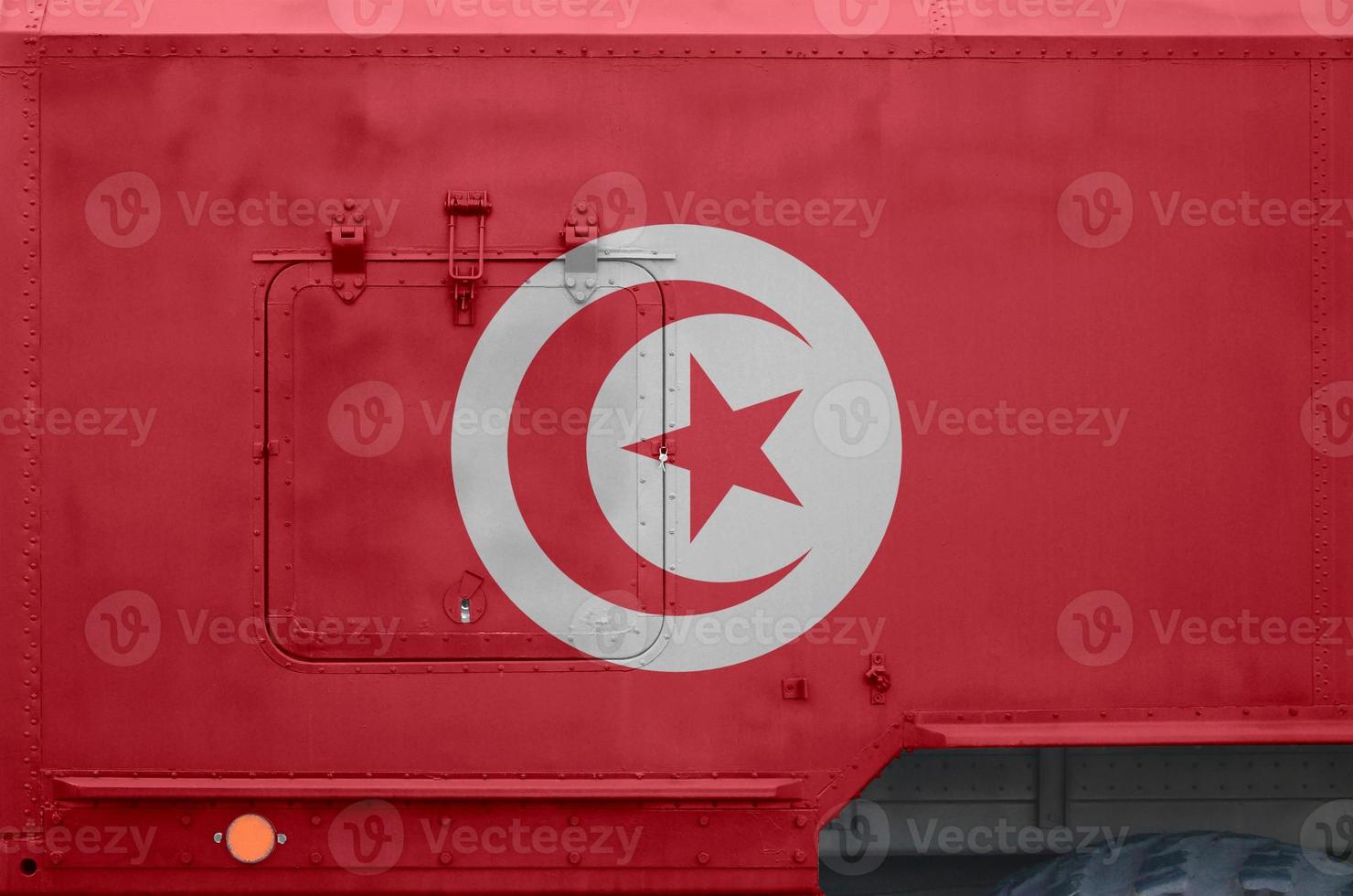 Tunisia flag depicted on side part of military armored truck closeup. Army forces conceptual background photo