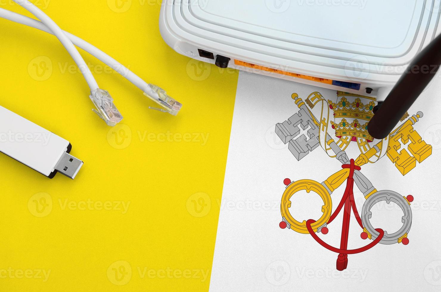 Vatican City State flag depicted on table with internet rj45 cable, wireless usb wifi adapter and router. Internet connection concept photo