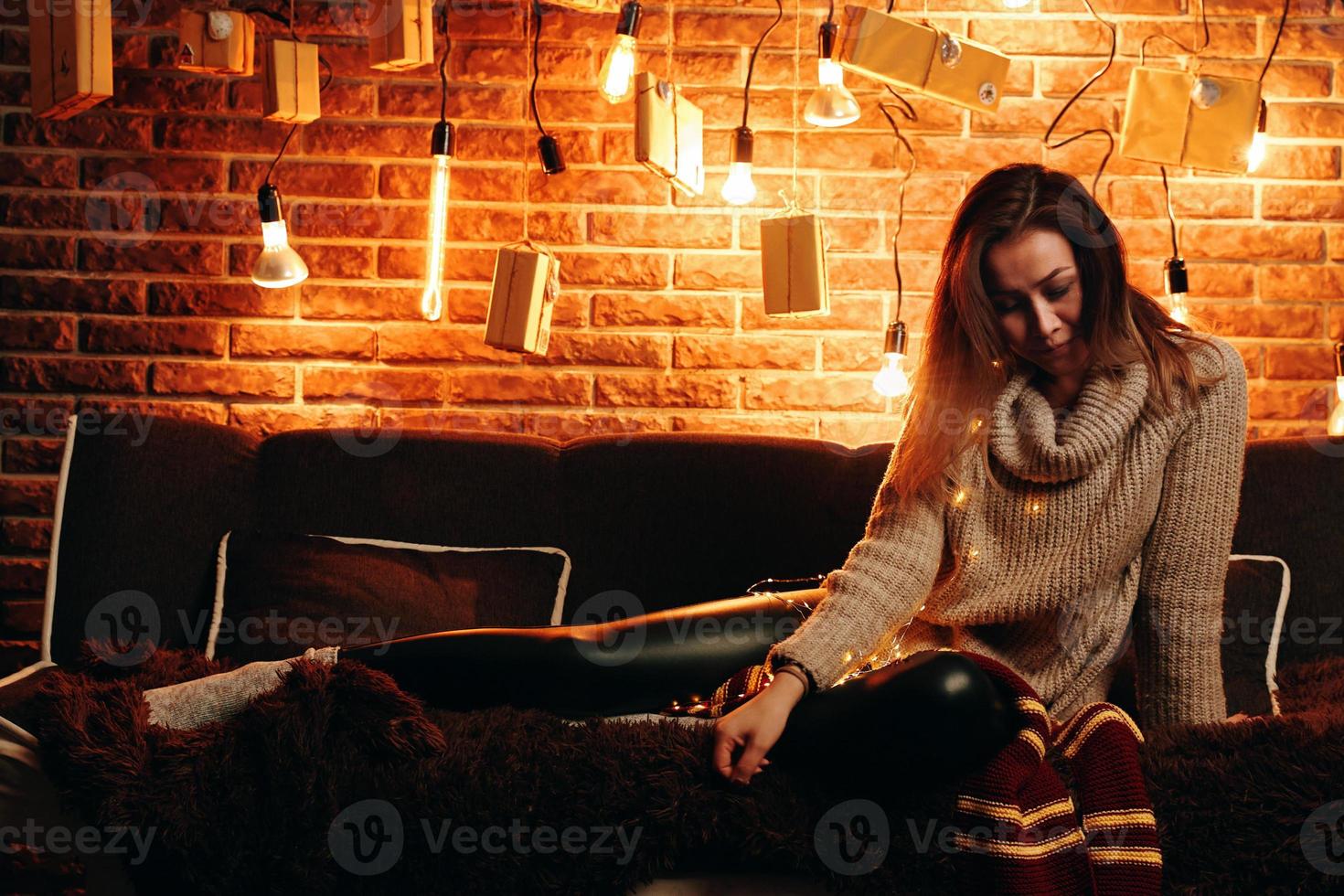 Cute girl sitting on the couch. photo