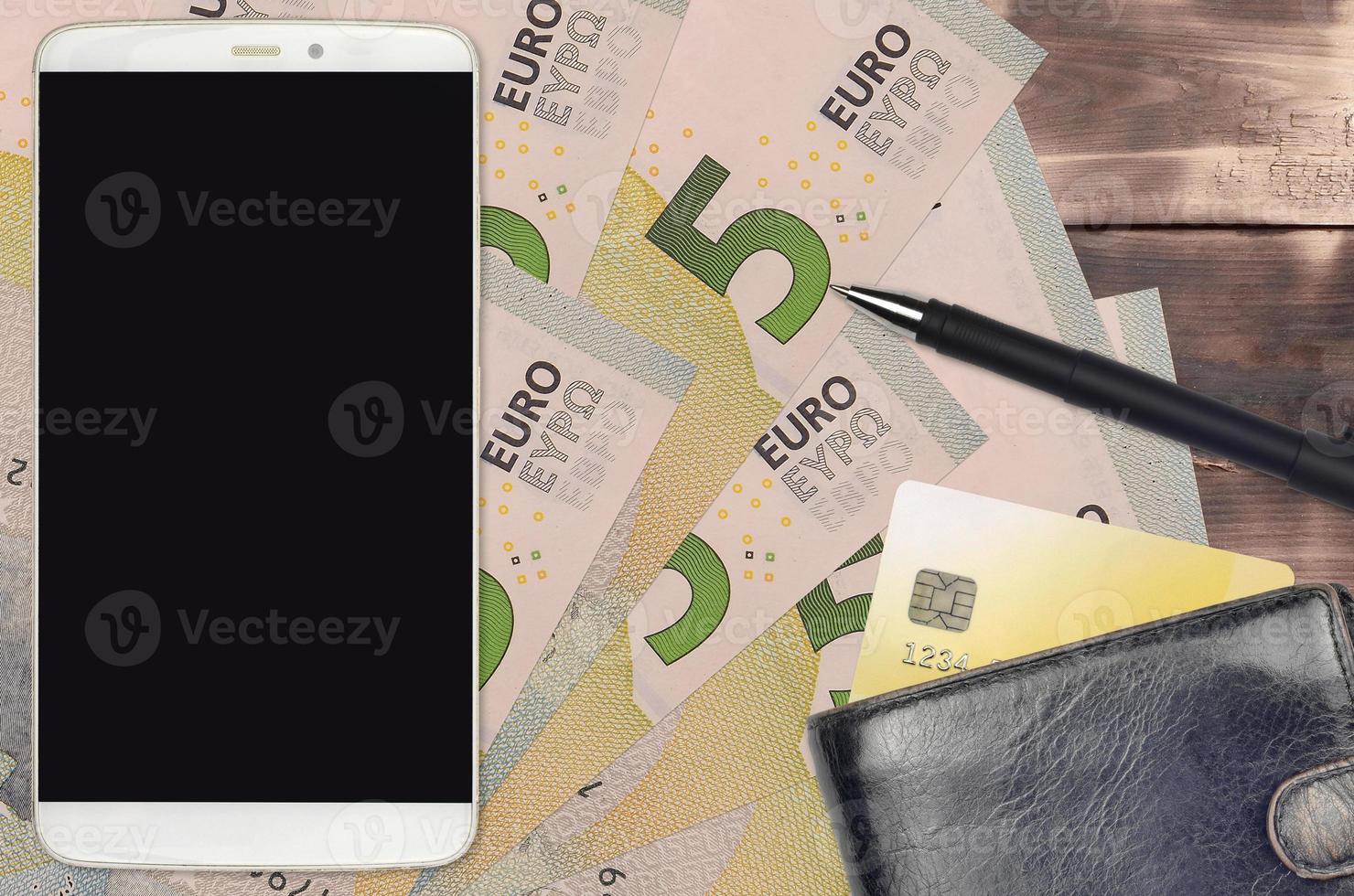 5 euro bills and smartphone with purse and credit card. E-payments or e-commerce concept. Online shopping and business with portable devices photo
