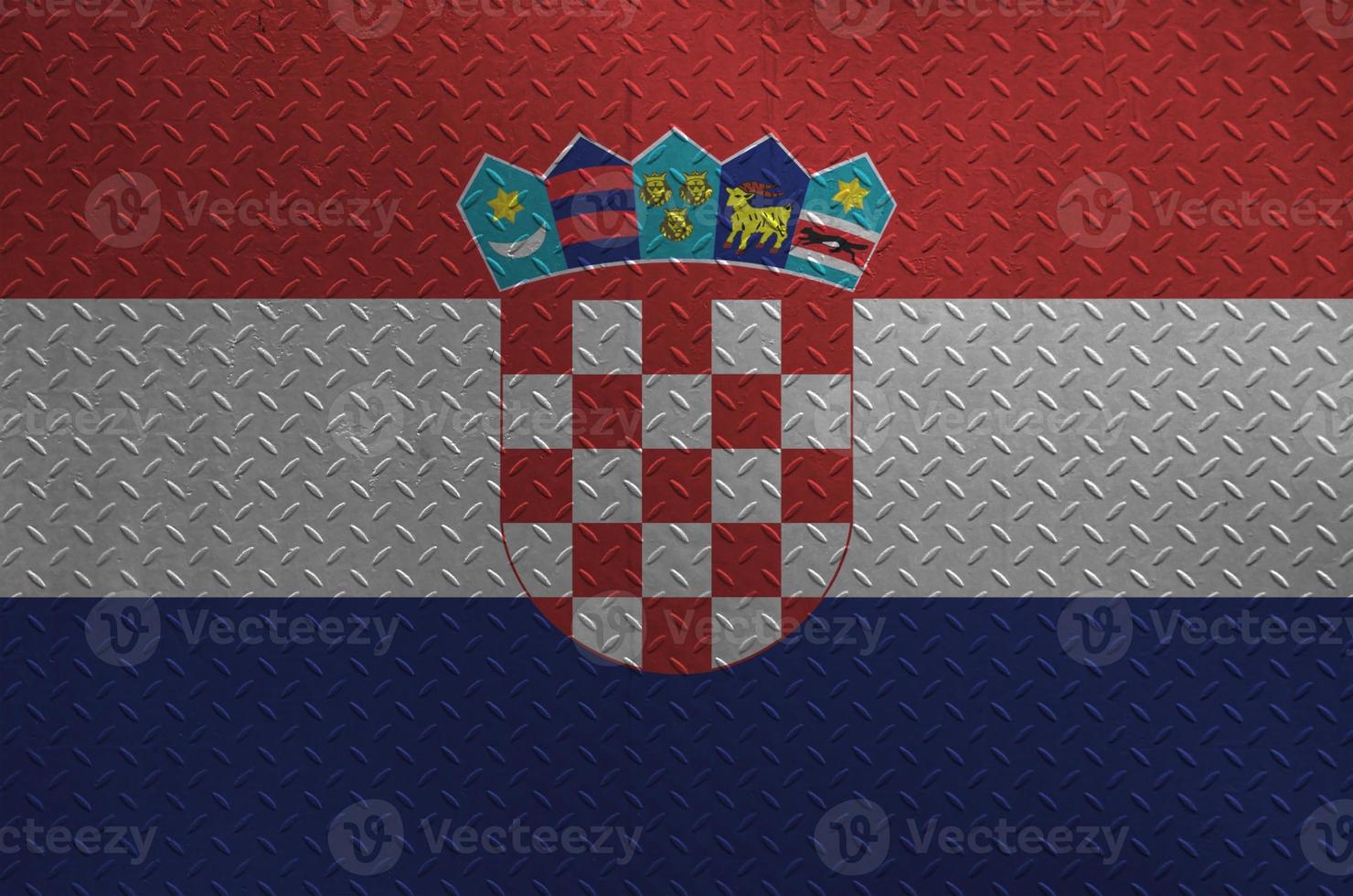 Croatia flag depicted in paint colors on old brushed metal plate or wall closeup. Textured banner on rough background photo