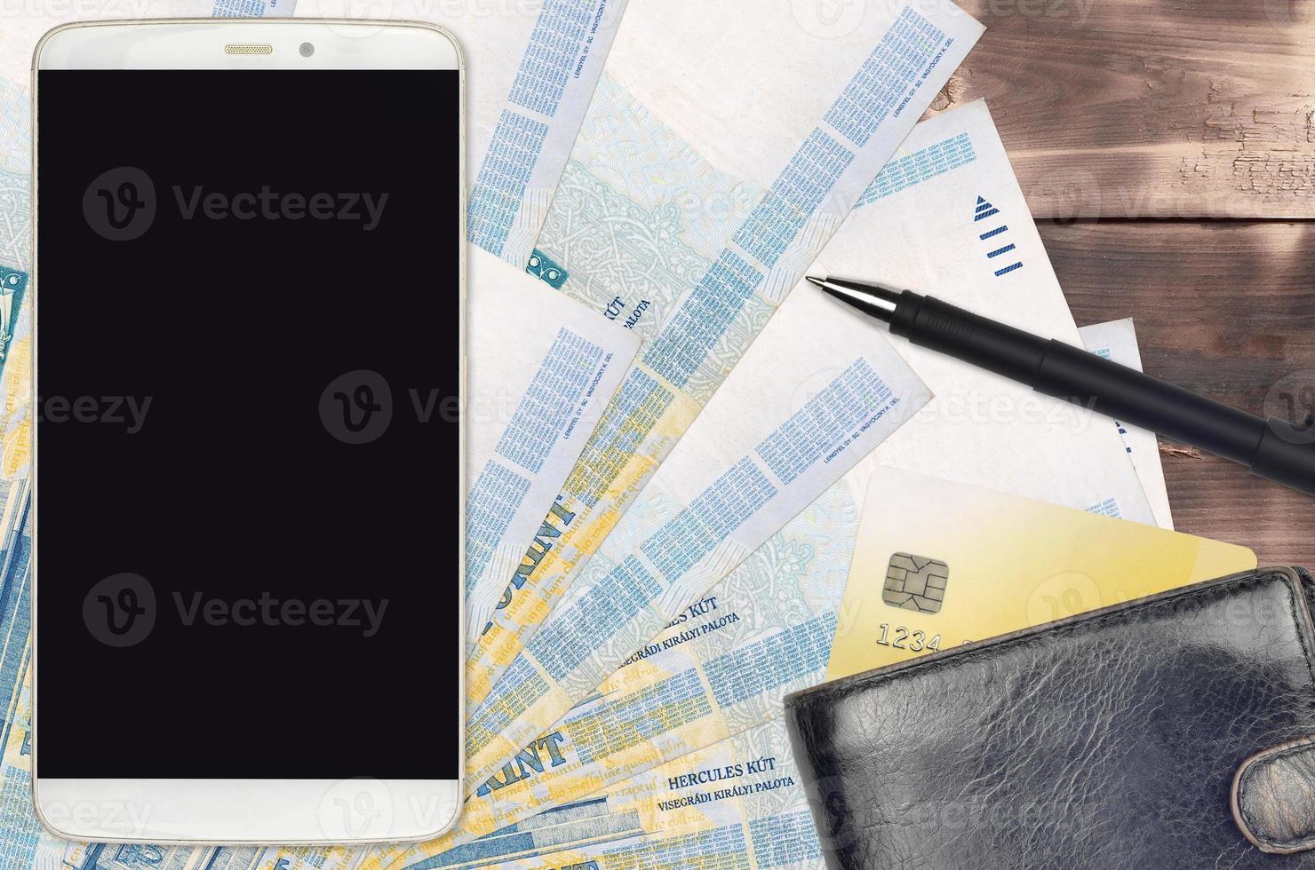 1000 Hungarian forint bills and smartphone with purse and credit card. E-payments or e-commerce concept. Online shopping and business with portable devices photo