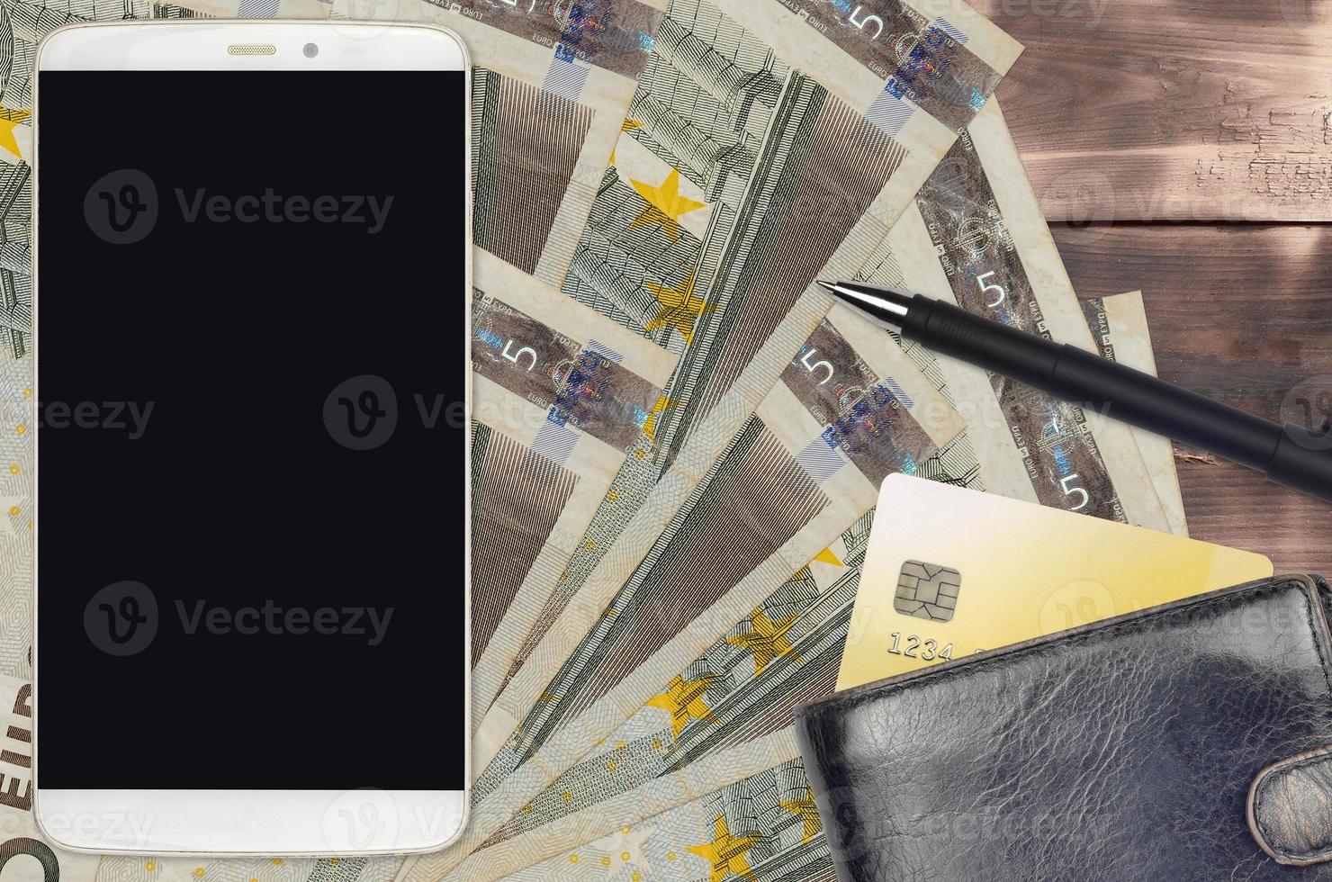 5 euro bills and smartphone with purse and credit card. E-payments or e-commerce concept. Online shopping and business with portable devices photo