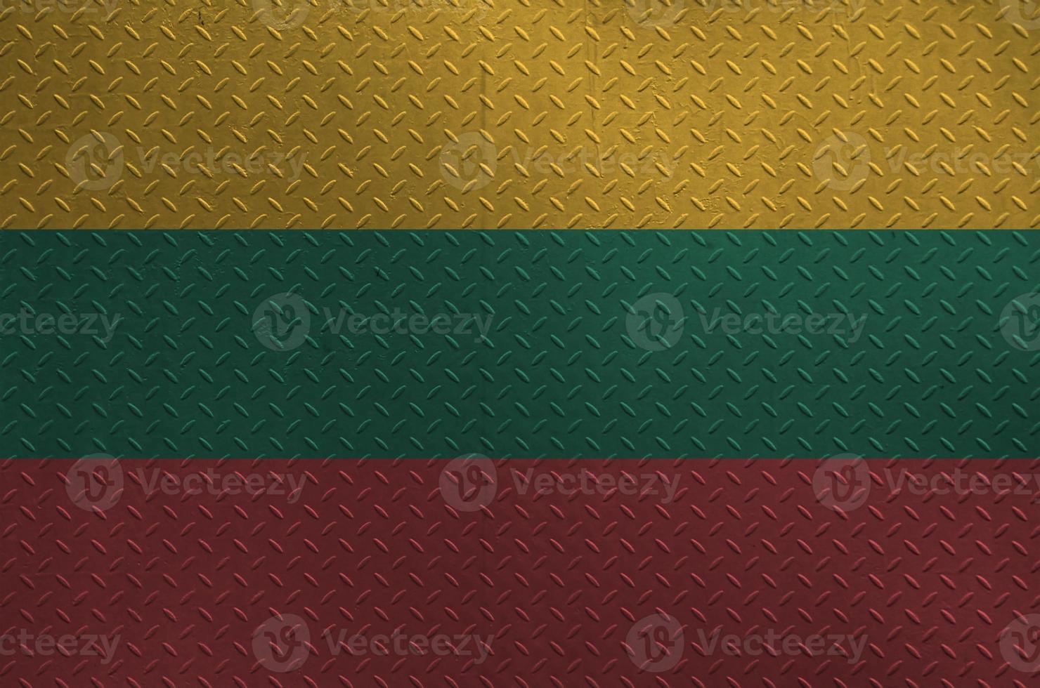 Lithuania flag depicted in paint colors on old brushed metal plate or wall closeup. Textured banner on rough background photo