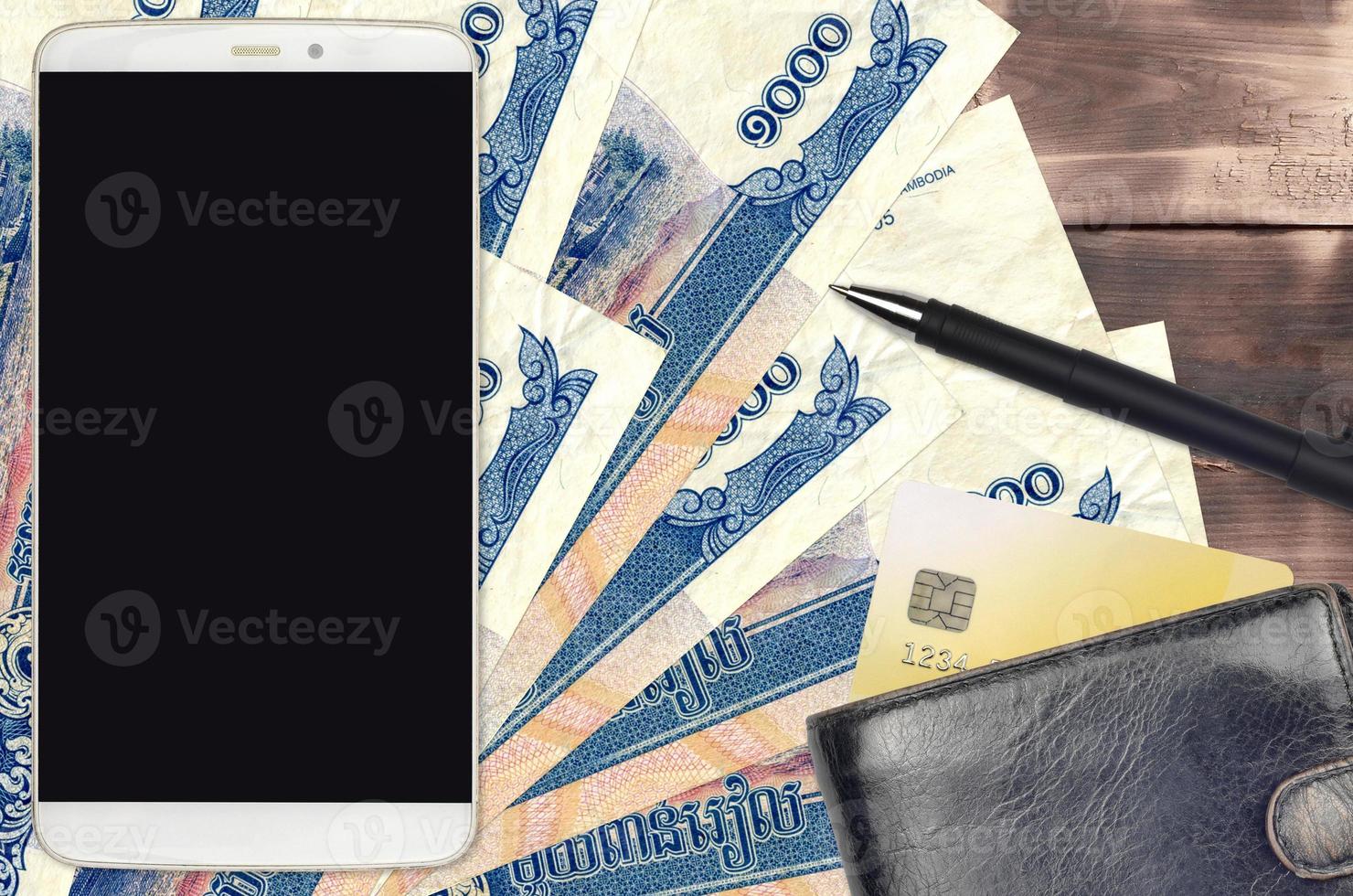 1000 Cambodian riels bills and smartphone with purse and credit card. E-payments or e-commerce concept. Online shopping and business with portable devices photo