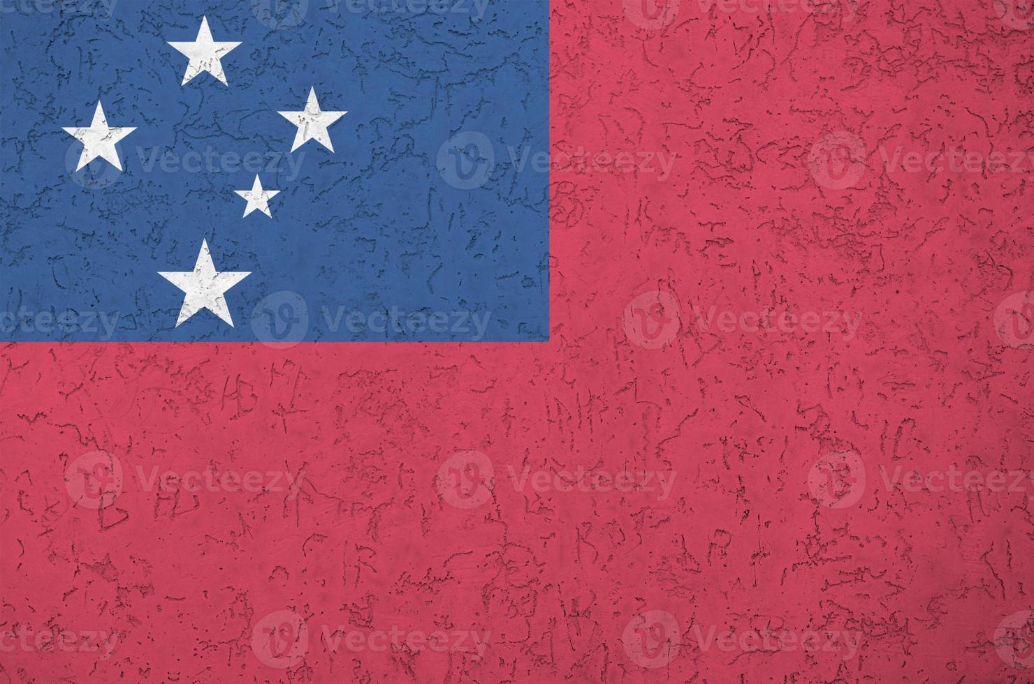 Samoa flag depicted in bright paint colors on old relief plastering wall. Textured banner on rough background photo