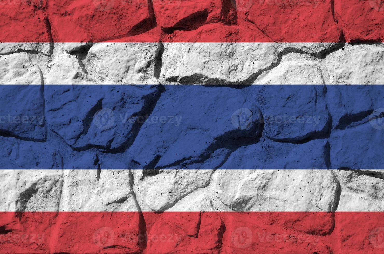 Thailand flag depicted in paint colors on old stone wall closeup. Textured banner on rock wall background photo