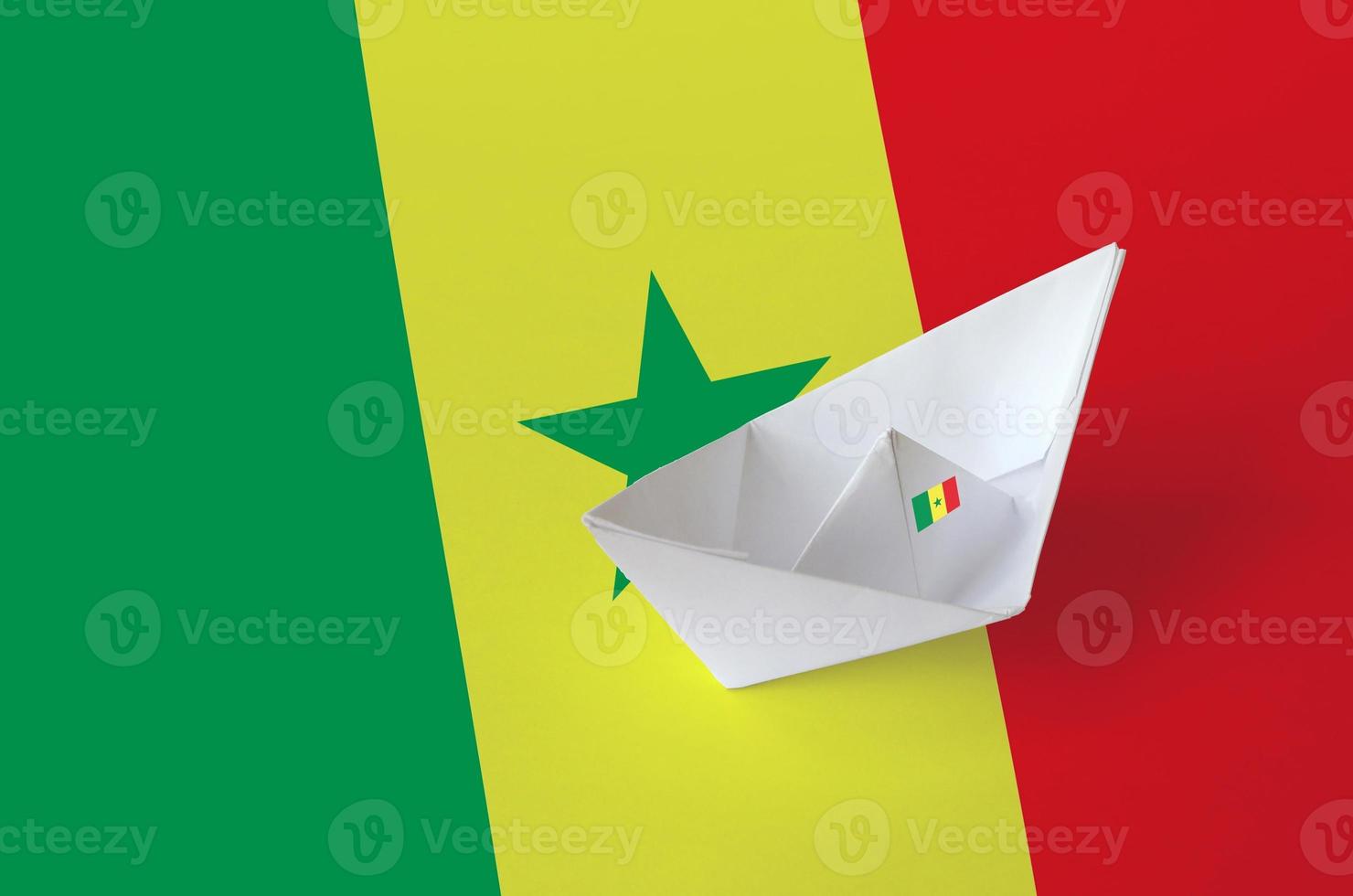 Senegal flag depicted on paper origami ship closeup. Handmade arts concept photo