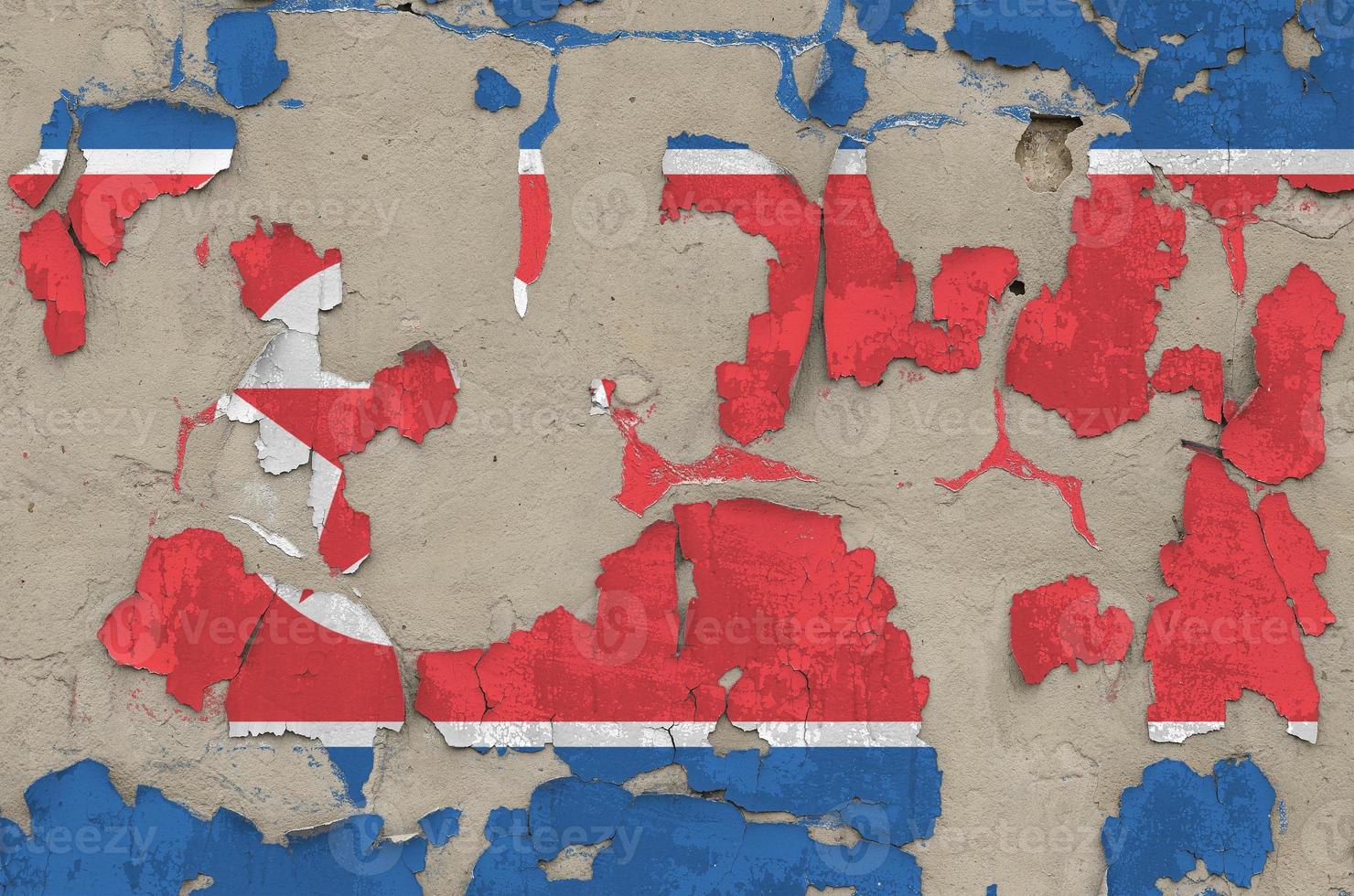 North Korea flag depicted in paint colors on old obsolete messy concrete wall closeup. Textured banner on rough background photo