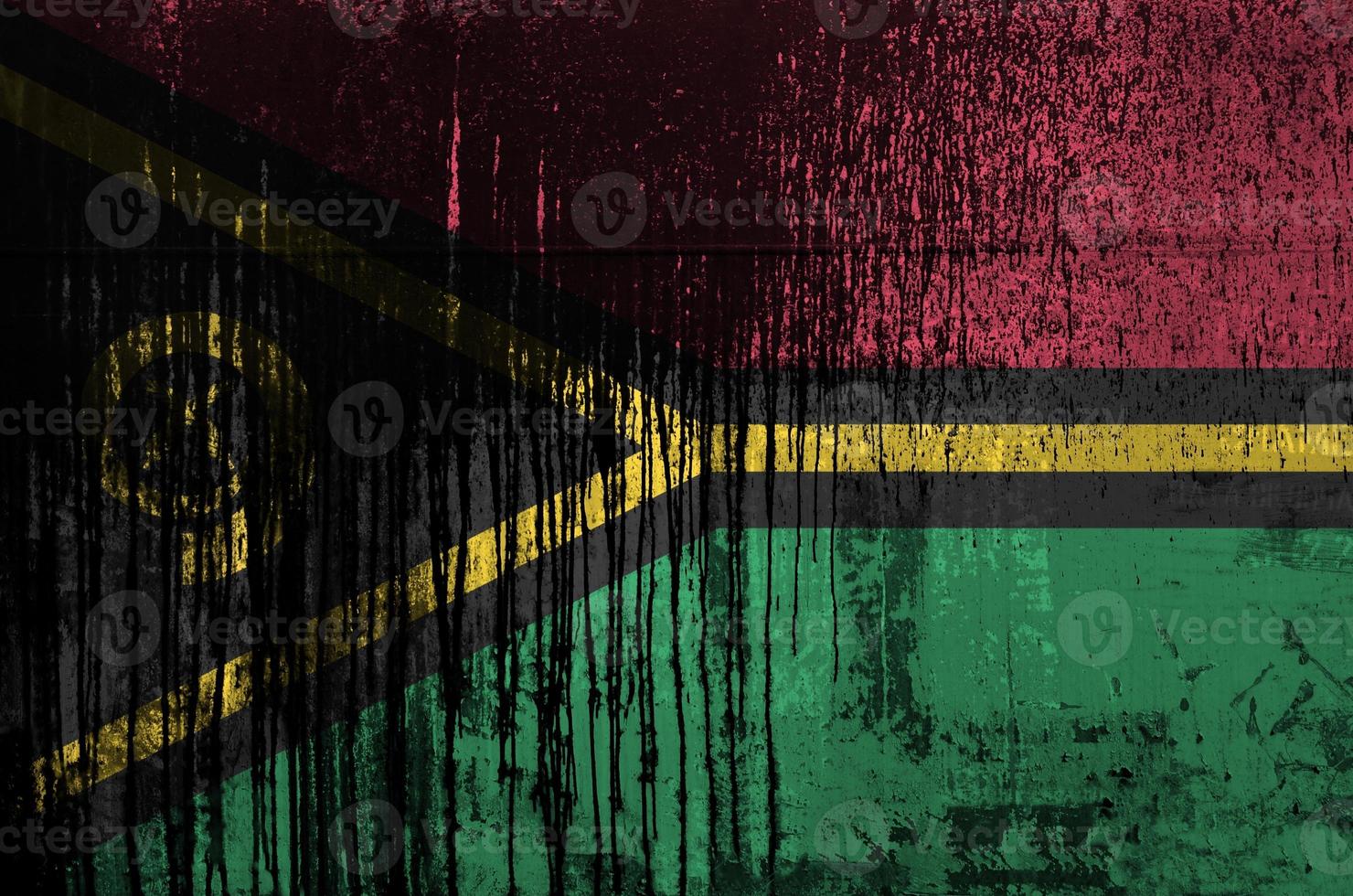 Vanuatu flag depicted in paint colors on old and dirty oil barrel wall closeup. Textured banner on rough background photo