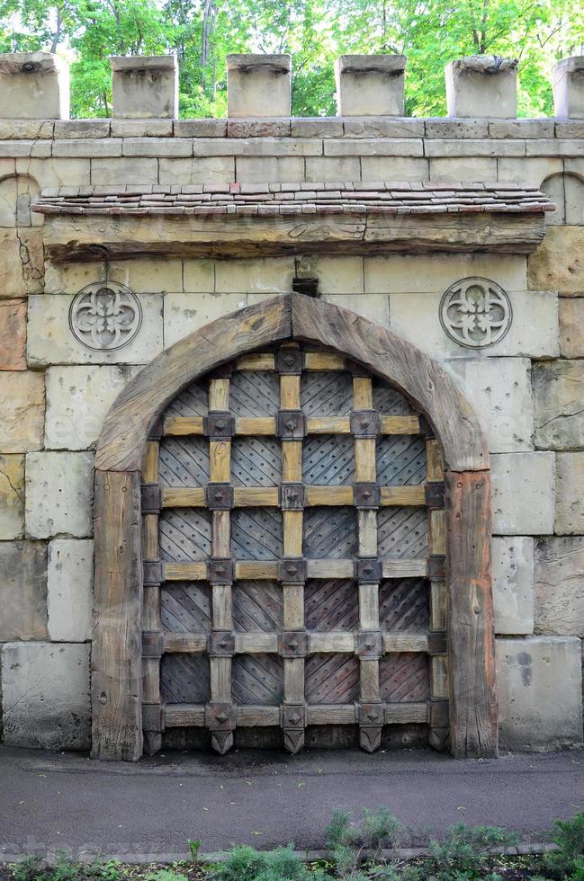 Old style wooden door from medieval era. Entrance to an antique place photo