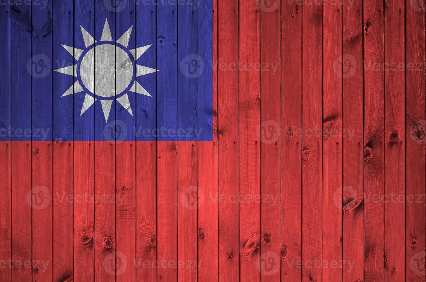 Taiwan flag depicted in bright paint colors on old wooden wall. Textured banner on rough background photo