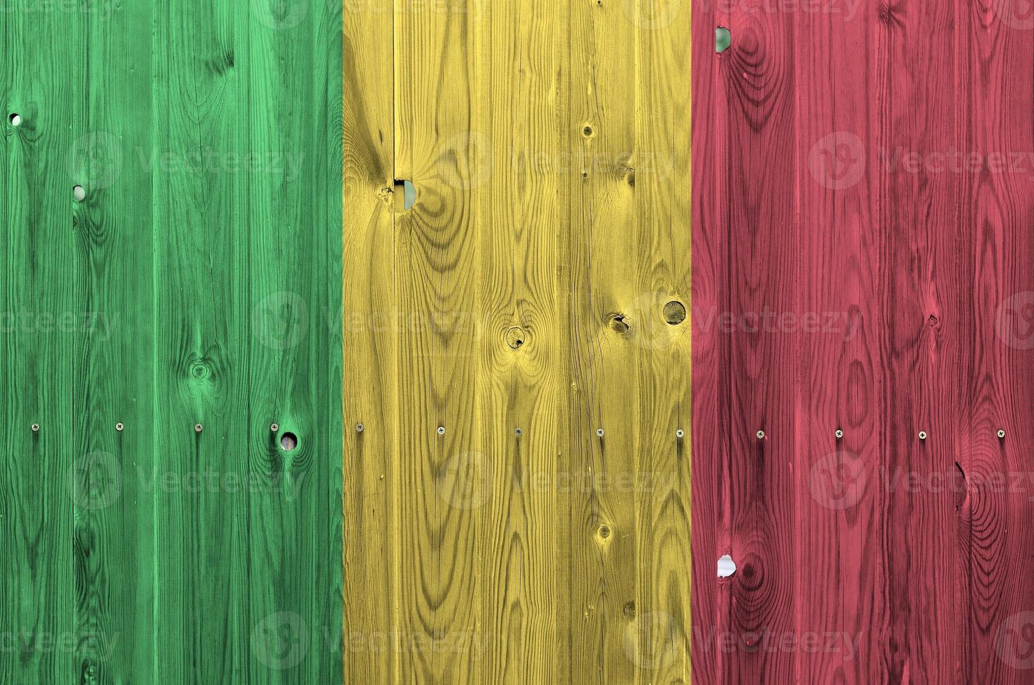 Mali flag depicted in bright paint colors on old wooden wall. Textured banner on rough background photo