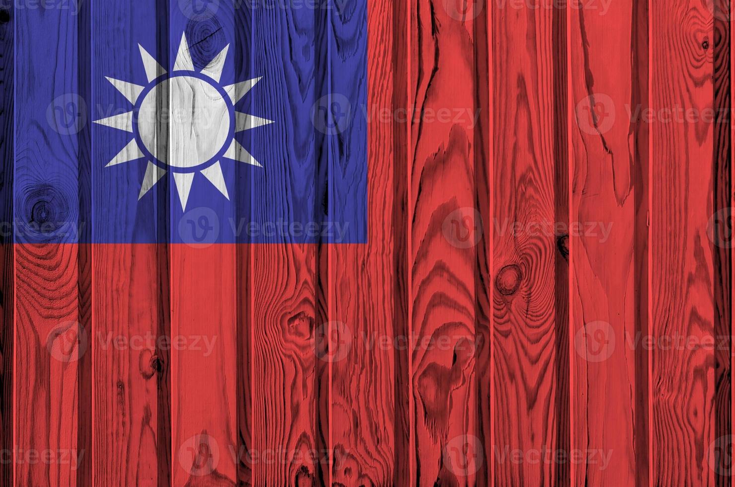 Taiwan flag depicted in bright paint colors on old wooden wall. Textured banner on rough background photo