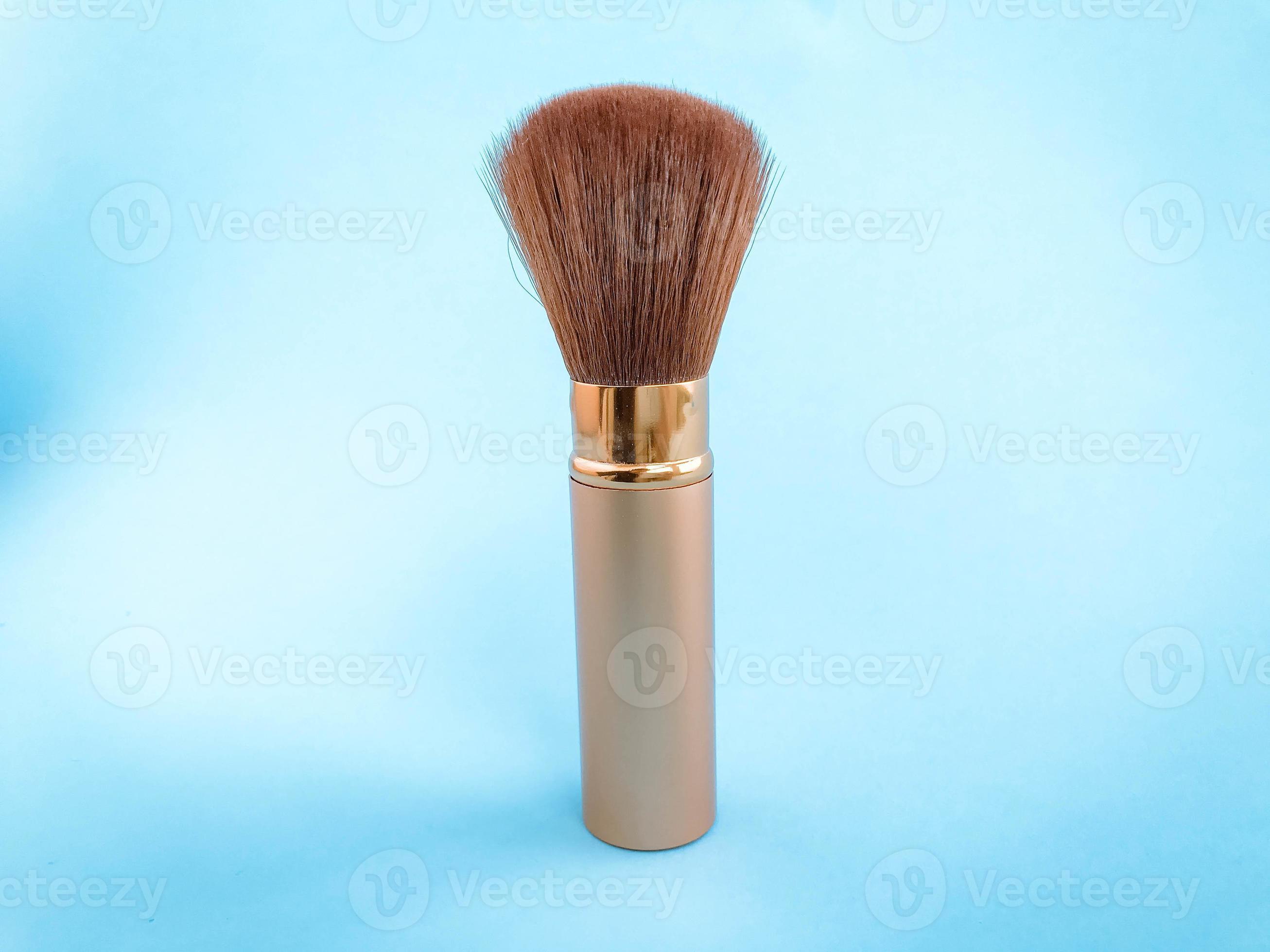 fluffy brush with natural bristles on a blue matte background. brush
