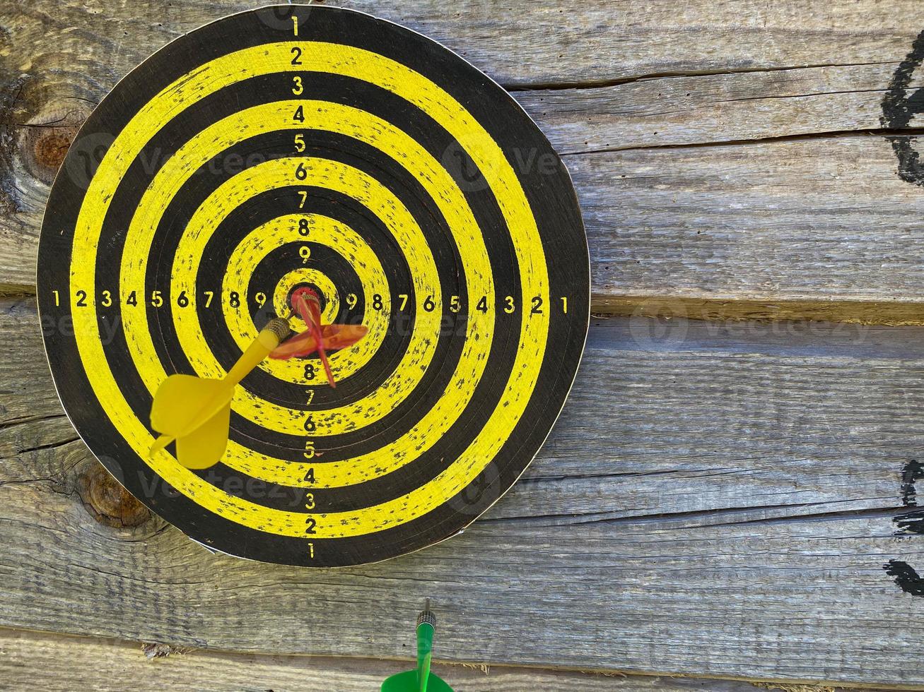 Dart in bulls eye of dartboard concept for hitting target dart success concept photo