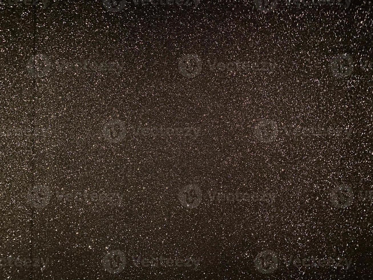 Black shiny texture, sequins with blur background photo