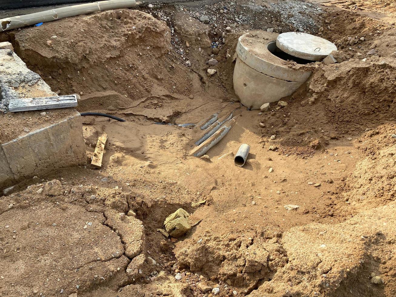 Concrete manhole in a pit at a construction site. Industrial construction of sewerage engineering networks photo