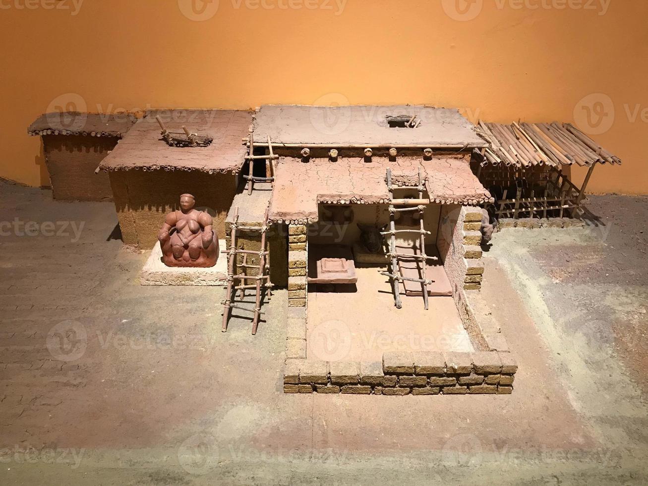 A small clay model of an ancient building in a museum photo