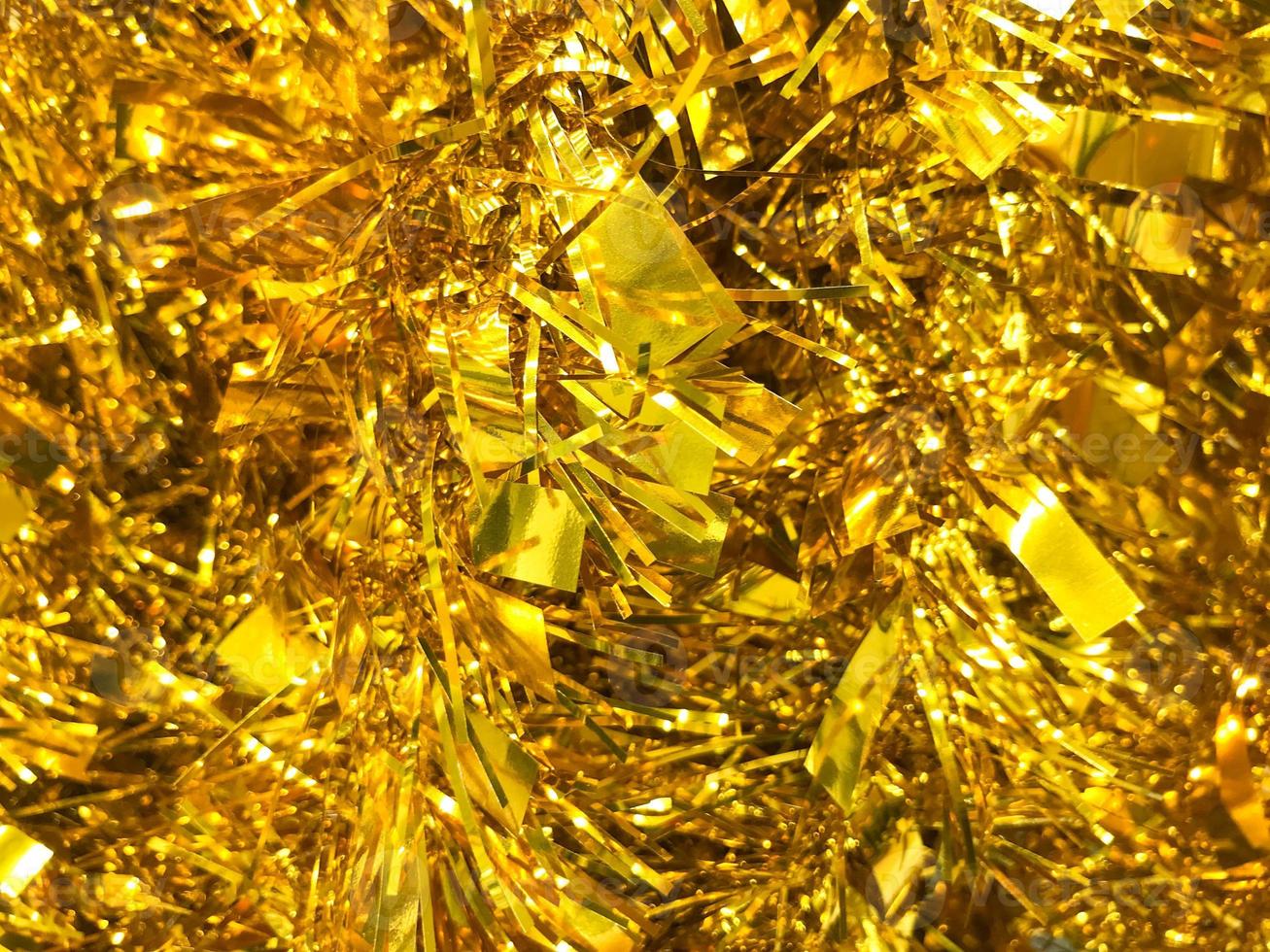 a lot of New Year's golden garland . Christmas. yellow shiny background photo