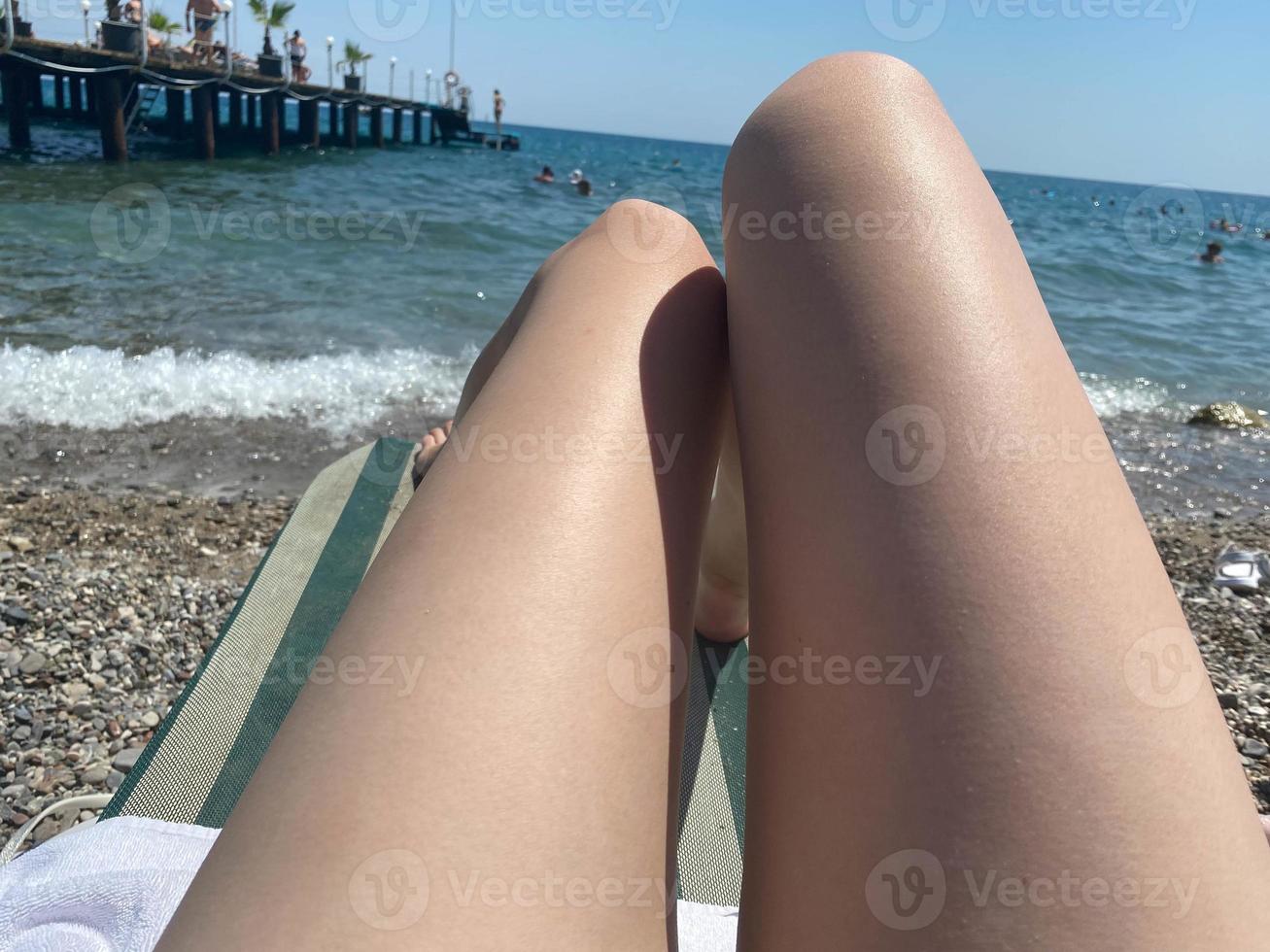 Low Section Of Woman On Relaxing On Hammock At Beach photo