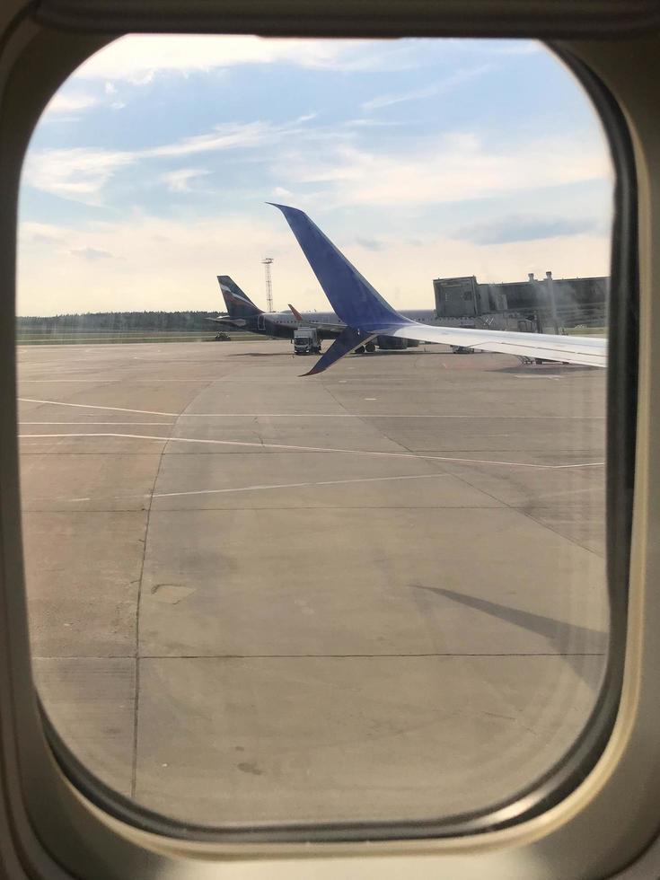 Airplane wing with beautiful sky from airplane window photo