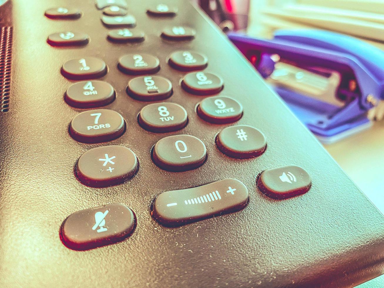 Office phone with large buttons on wooden table. photo