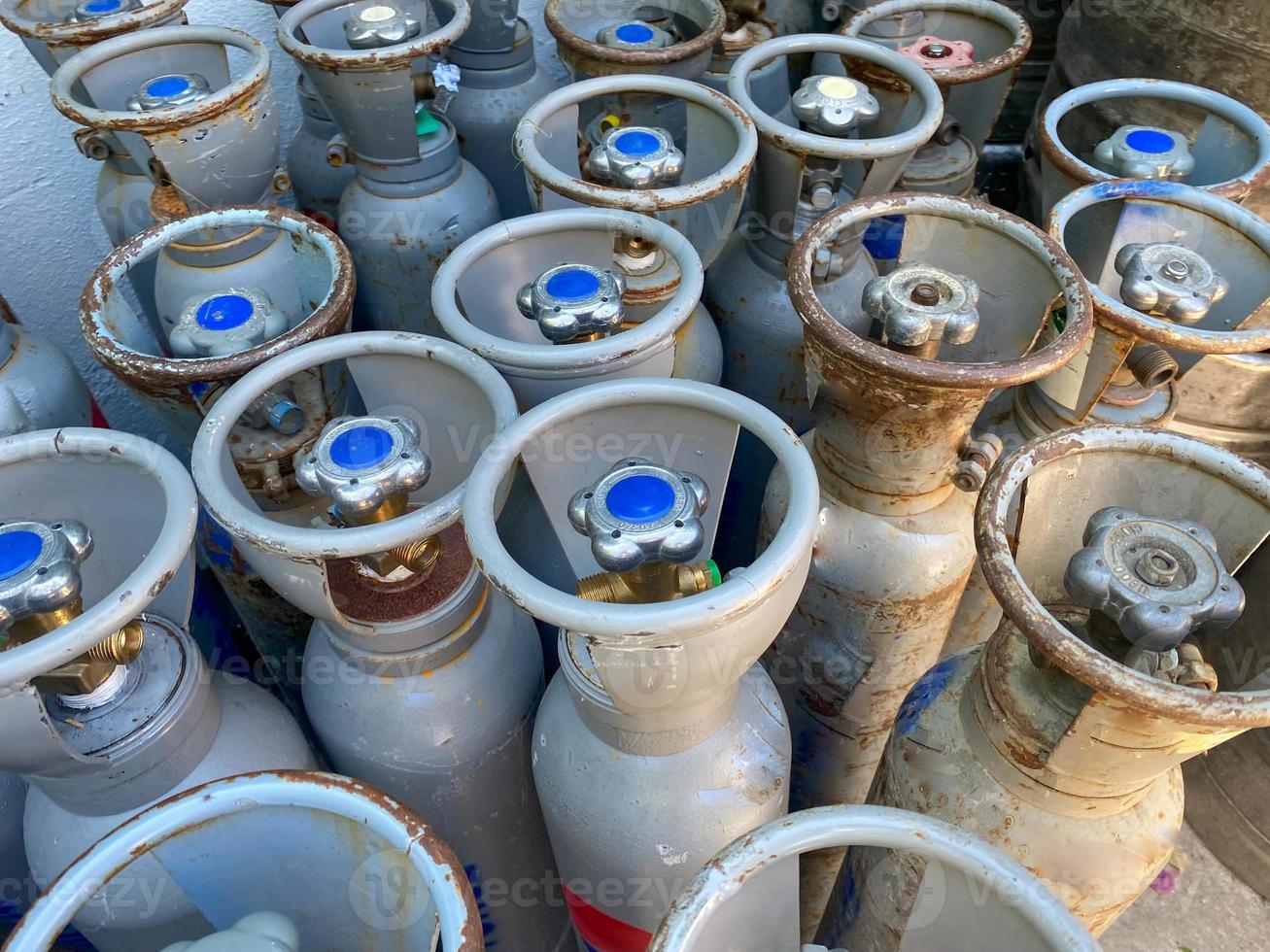 Many large metal, aluminum oxygen cylinders for breathing and diving stand on special stands on board a boat, ship, cruise liner photo