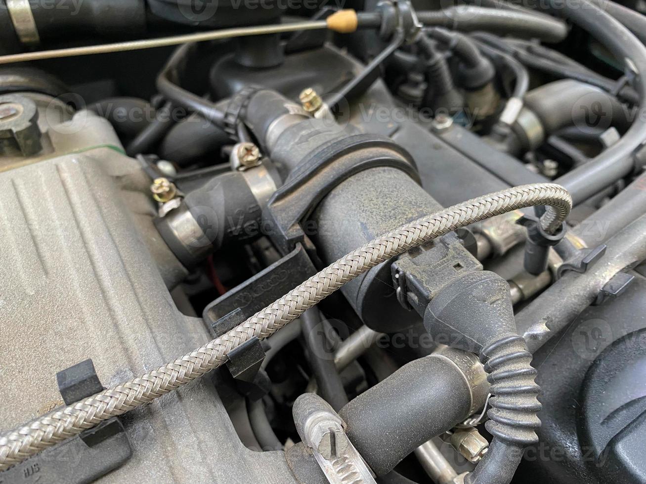 New car alternator, close-up view. An alternator installed in the engine compartment of a modern car. Diagnostics and repair of a modern car, original spare parts. Electric equipment of the car photo