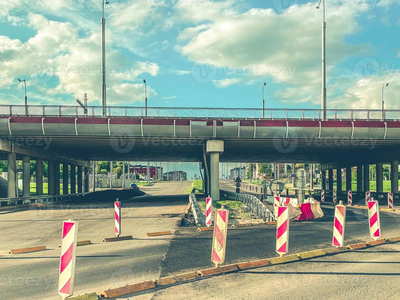 construction of a new area of the city. the road is fenced with protective elements, the construction of the highway. protective elements on the overpass photo