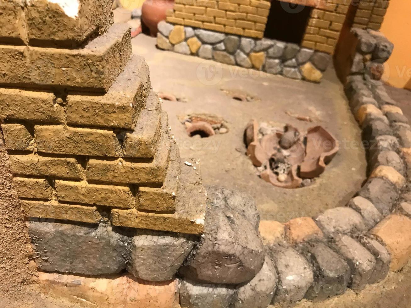 A small clay model of an ancient building in a museum photo