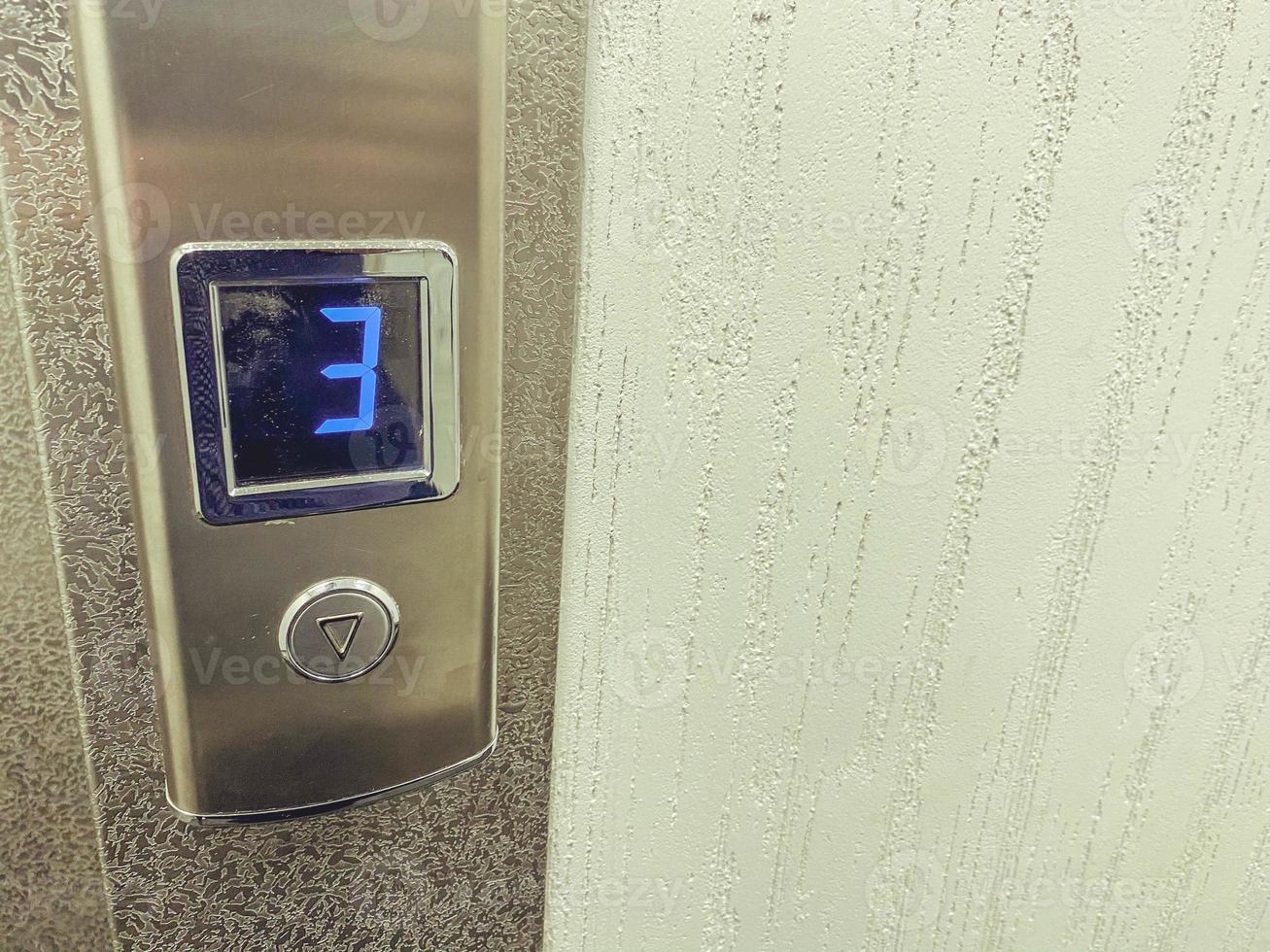 elevator button in a multi-storey building. the elevator on the third floor goes down. elevator to the upper floors. high speed elevator. modern metal lift photo