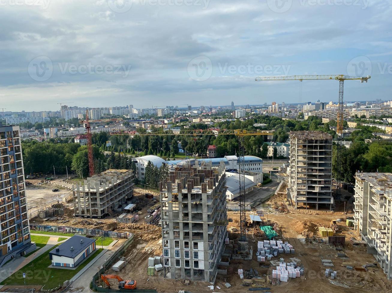 A view from a height of a large modern construction site of tall large houses and multi-storey buildings. A construction site for the development of a new microdistrict in a big city photo