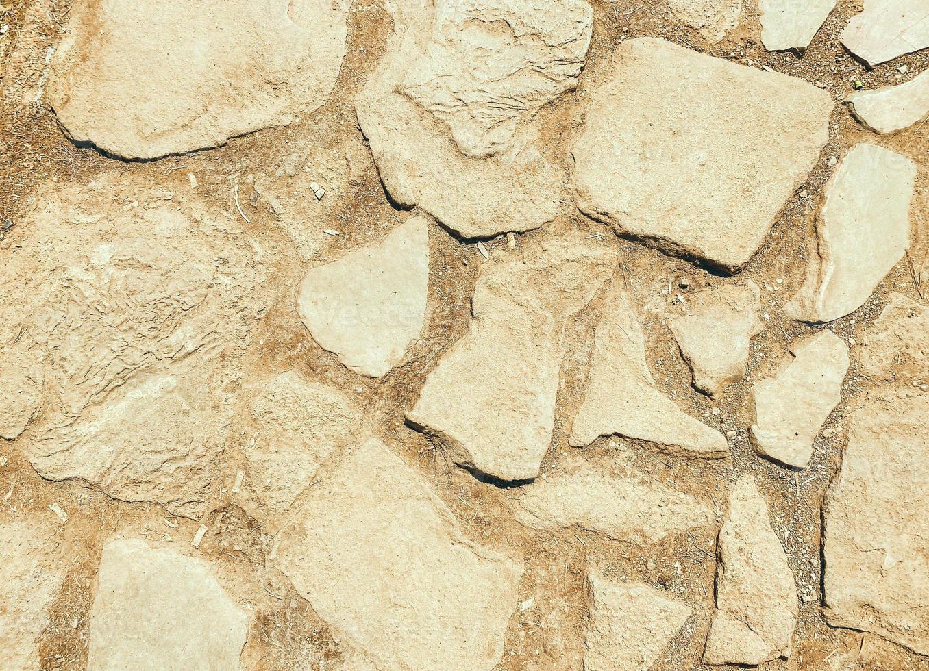 the stone is natural, the path is lined with stones for the convenience of tourists. natural beige texture. large stones of different colors to create roads photo